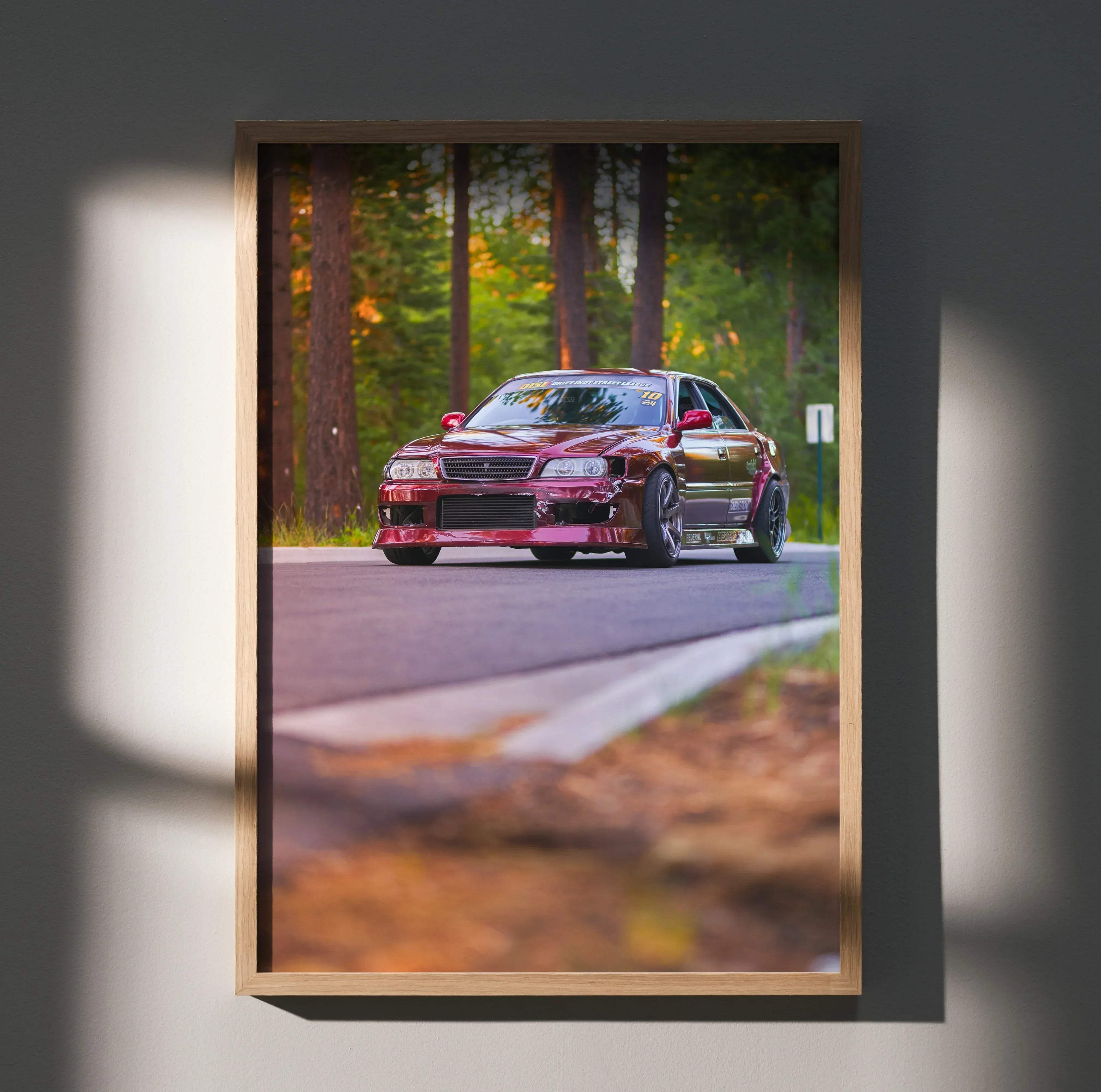 A framed high resolution wall art poster of a maroon toyota chaser jdm drift car speeding on a forest road