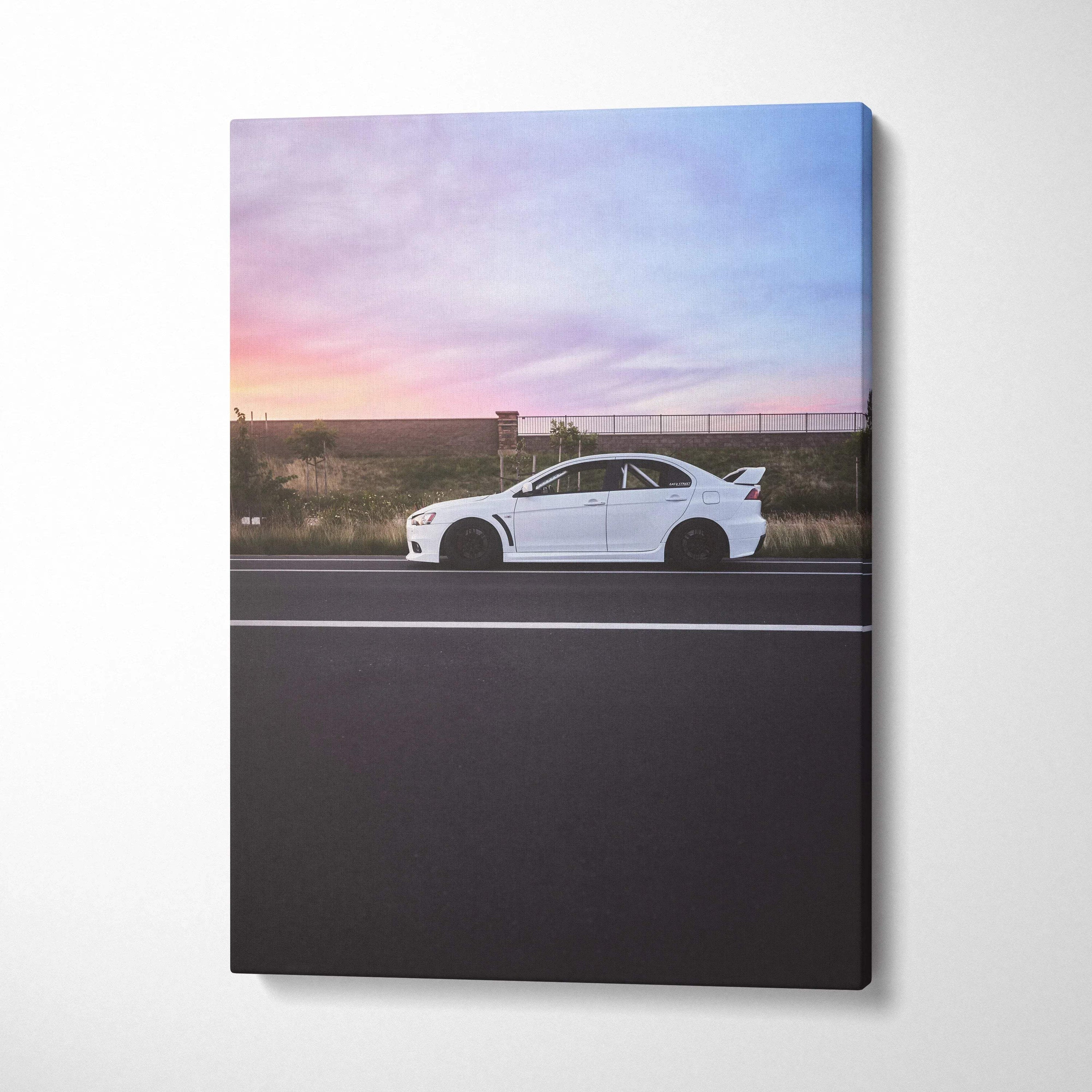 White Mitsubishi Evo 10 car against sunset sky on vertical canvas wall art.