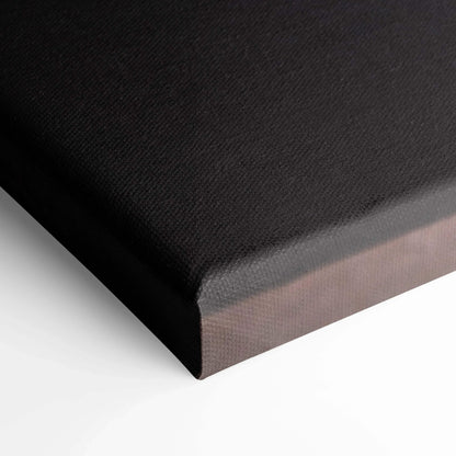 Black gallery-wrapped canvas wall art with fine texture and sharp vertical edges.