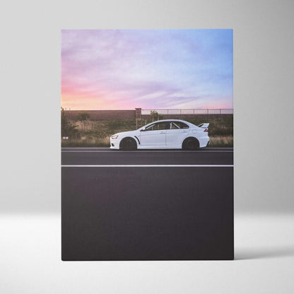 White Mitsubishi Evo 10 car against a sunset sky on vertical canvas wall art.