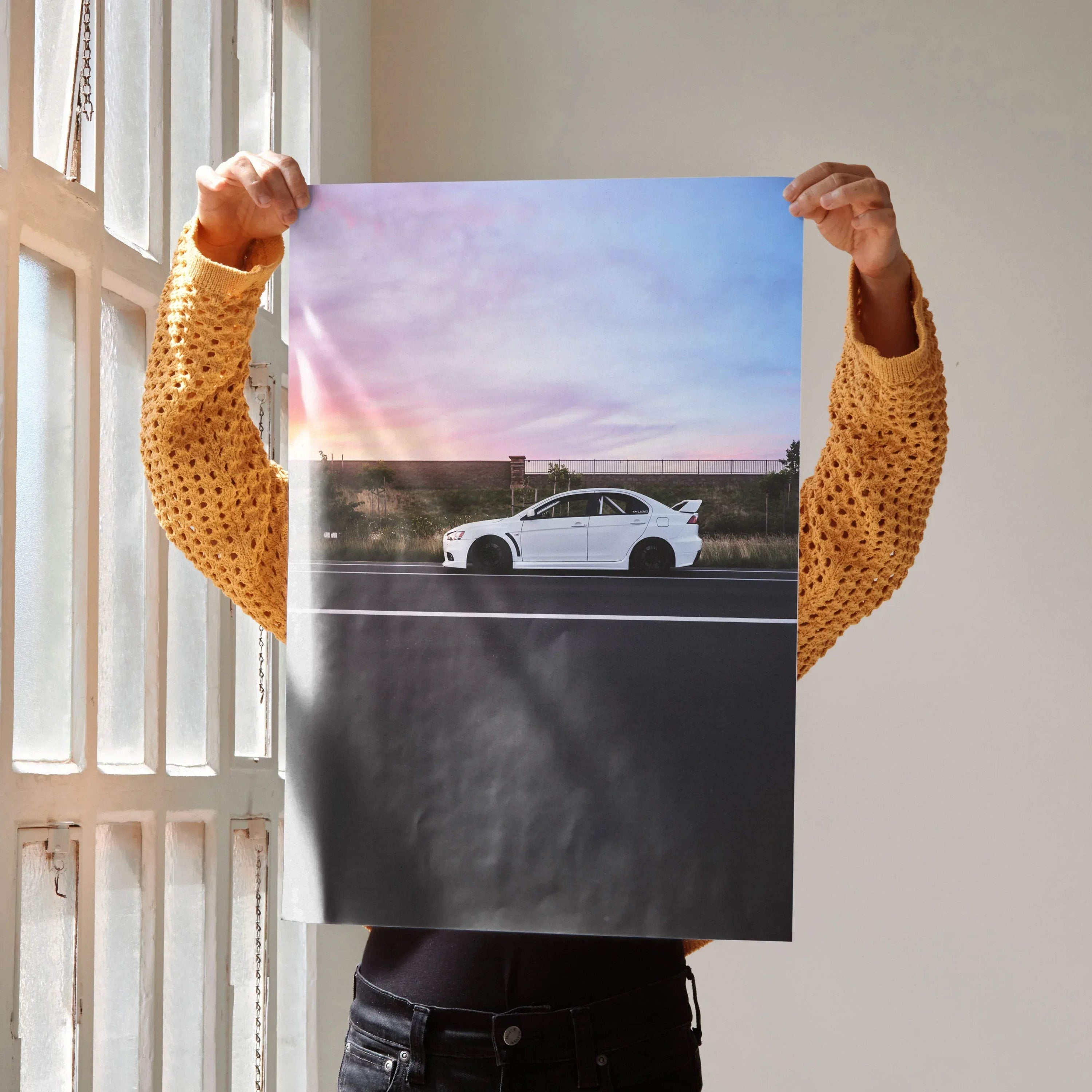 Mitsubishi Evo X poster wall art featuring white Evo 10 car at sunset with vibrant sky colors.