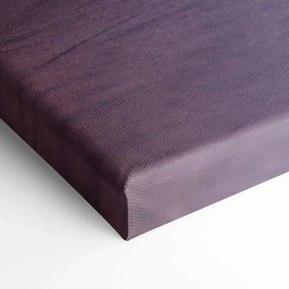 Close-up of textured purple canvas art canvas wrap corner with visible fabric grain and neat edge on white background.