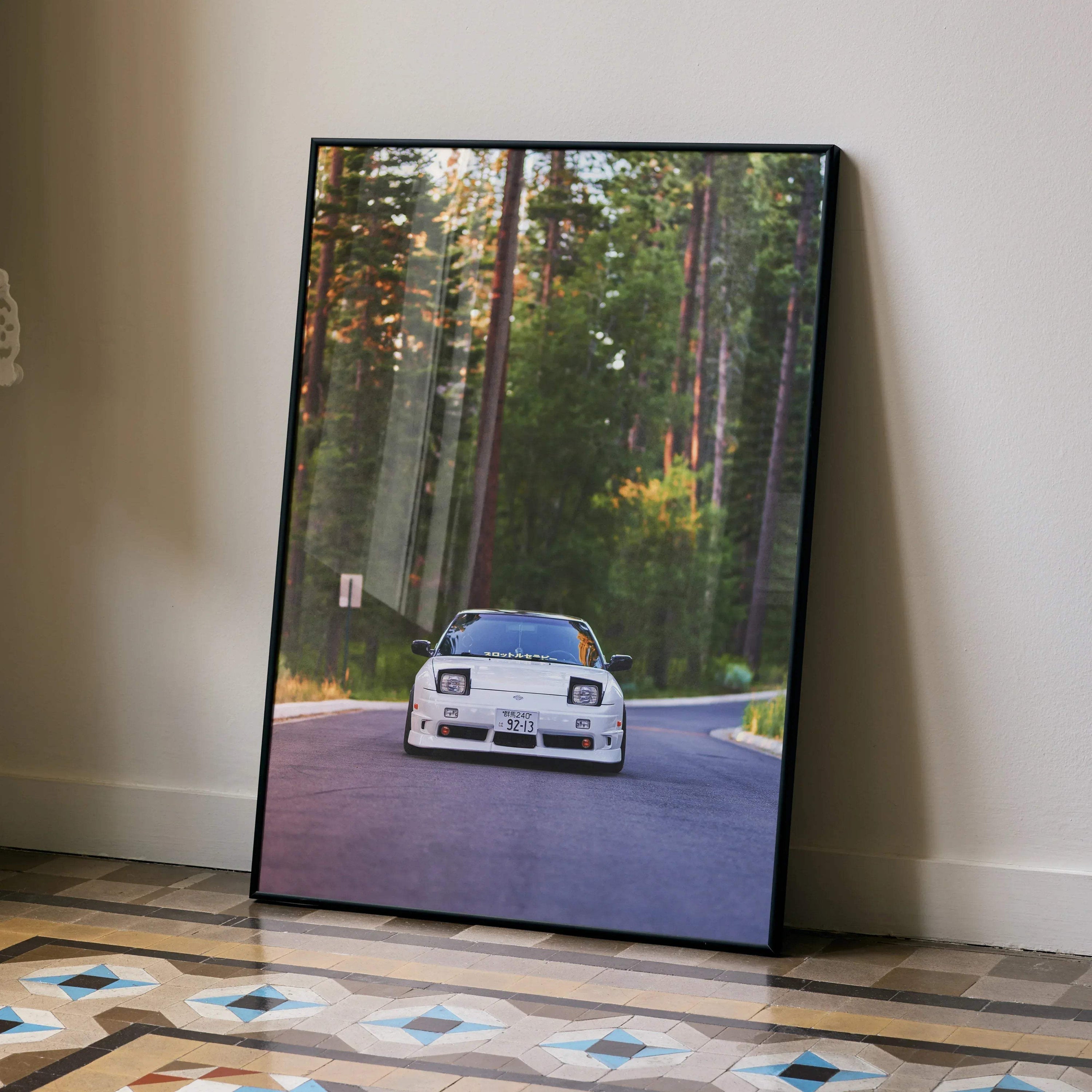 Nissan 240sx S13 Type-X framed poster showing white car on forest road, wall art in modern room.