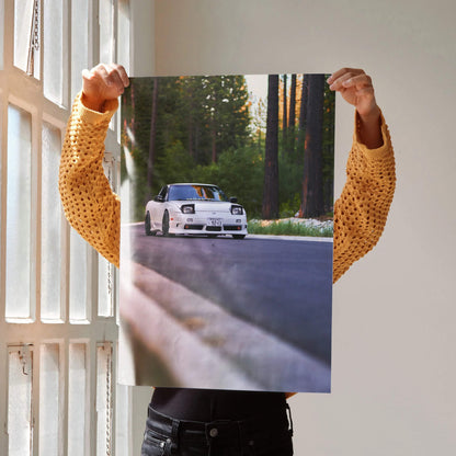 Nissan 240sx S13 Type-X driving on forest road poster wall art with sunlight and shadows.