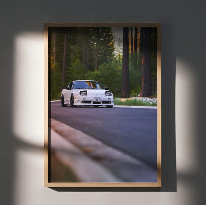 Nissan 240sx S13 Type-X driving on forest road poster wall art with natural wood frame.