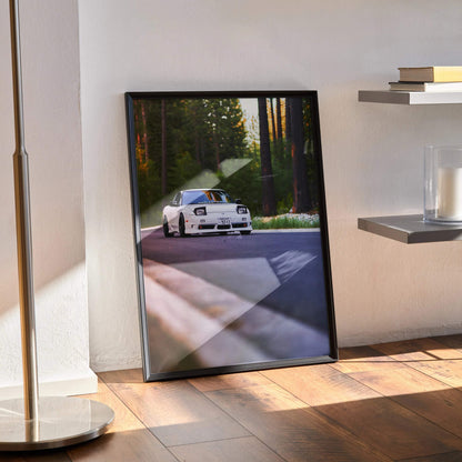 Nissan 240sx S13 Type-X poster leaning against wall with forest road scene, framed wall art.