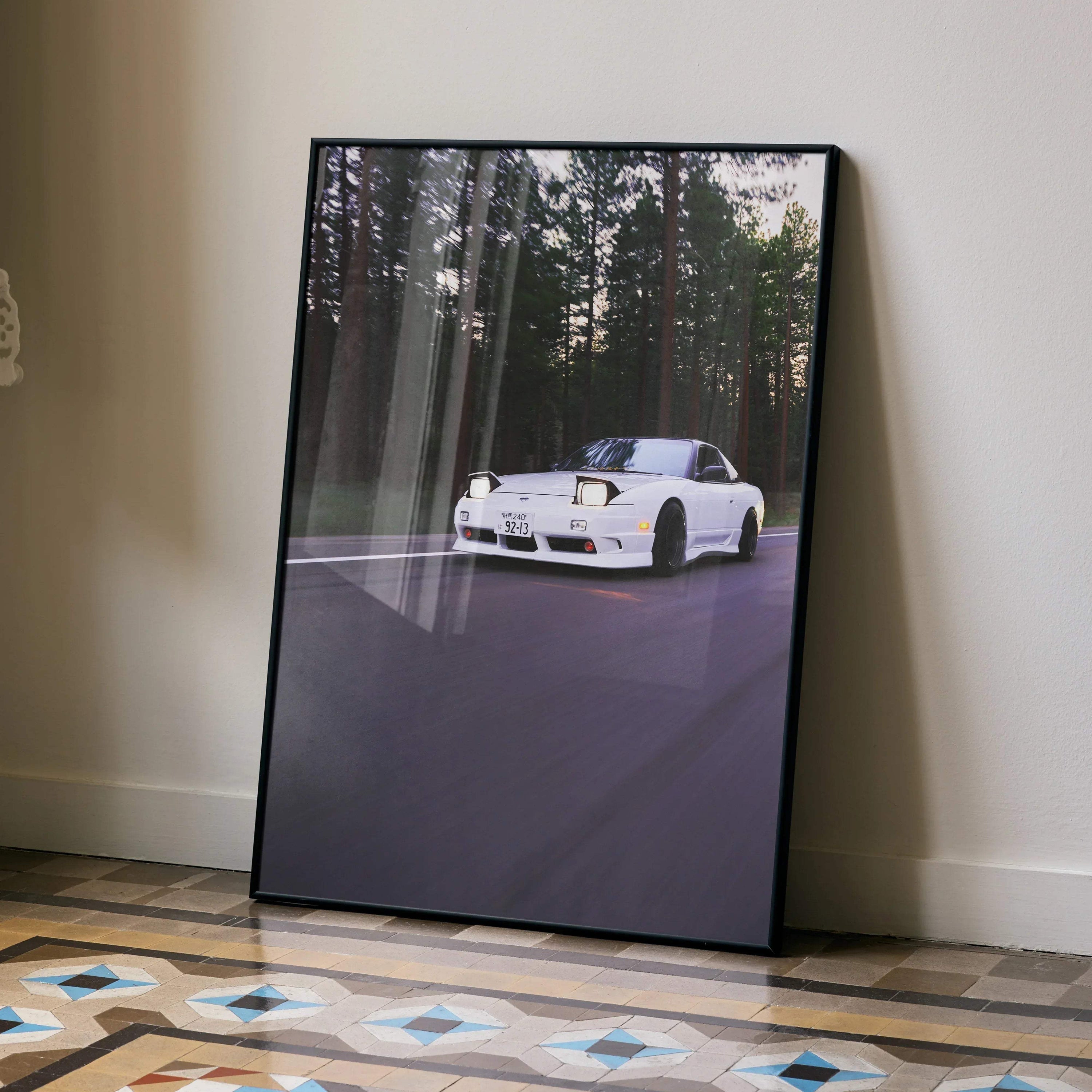 Nissan 240sx S13 Type-X poster showing white car on forest road wall art in black frame.