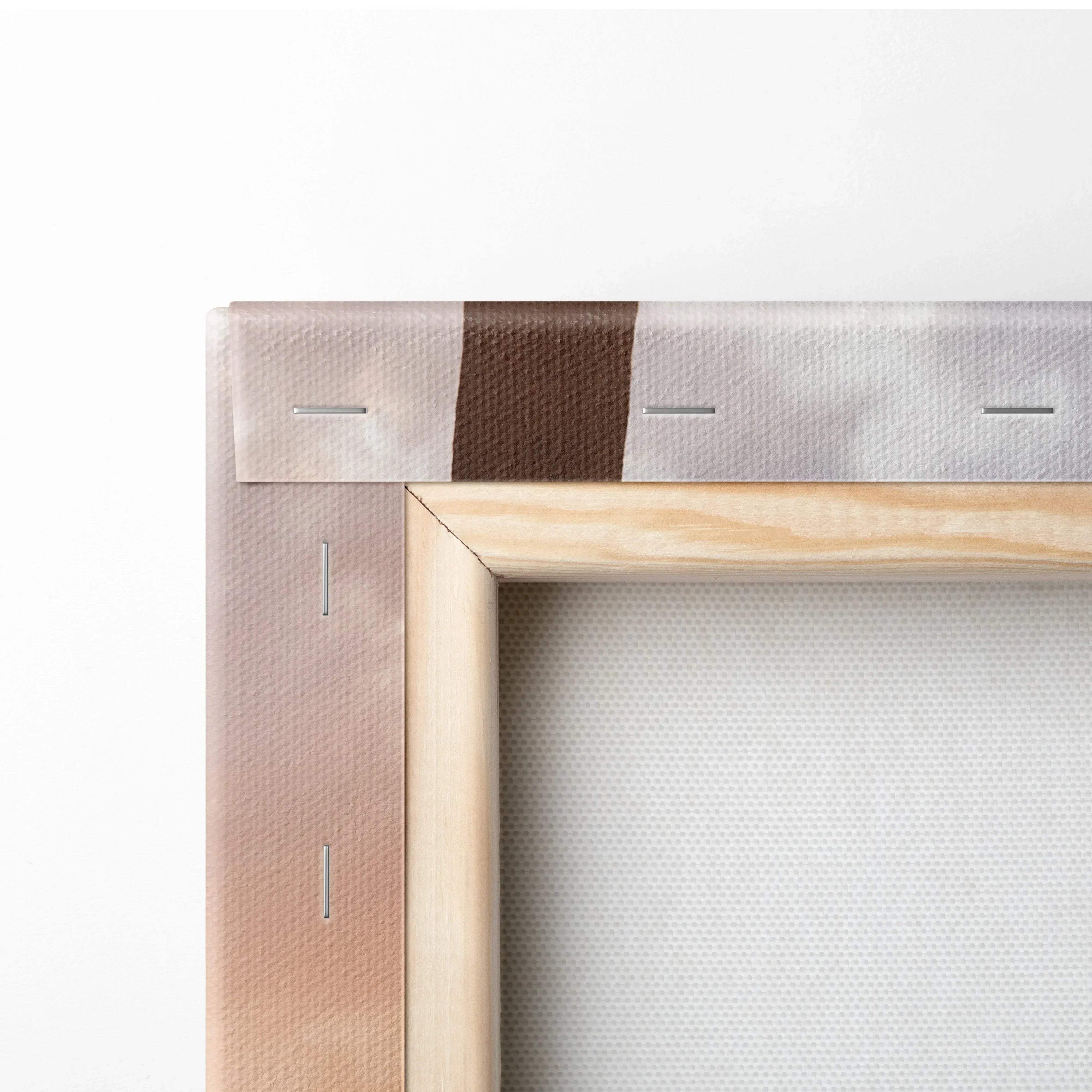 Close-up of wooden frame corner and canvas backing with brown and white printing, vertical wall art detail.