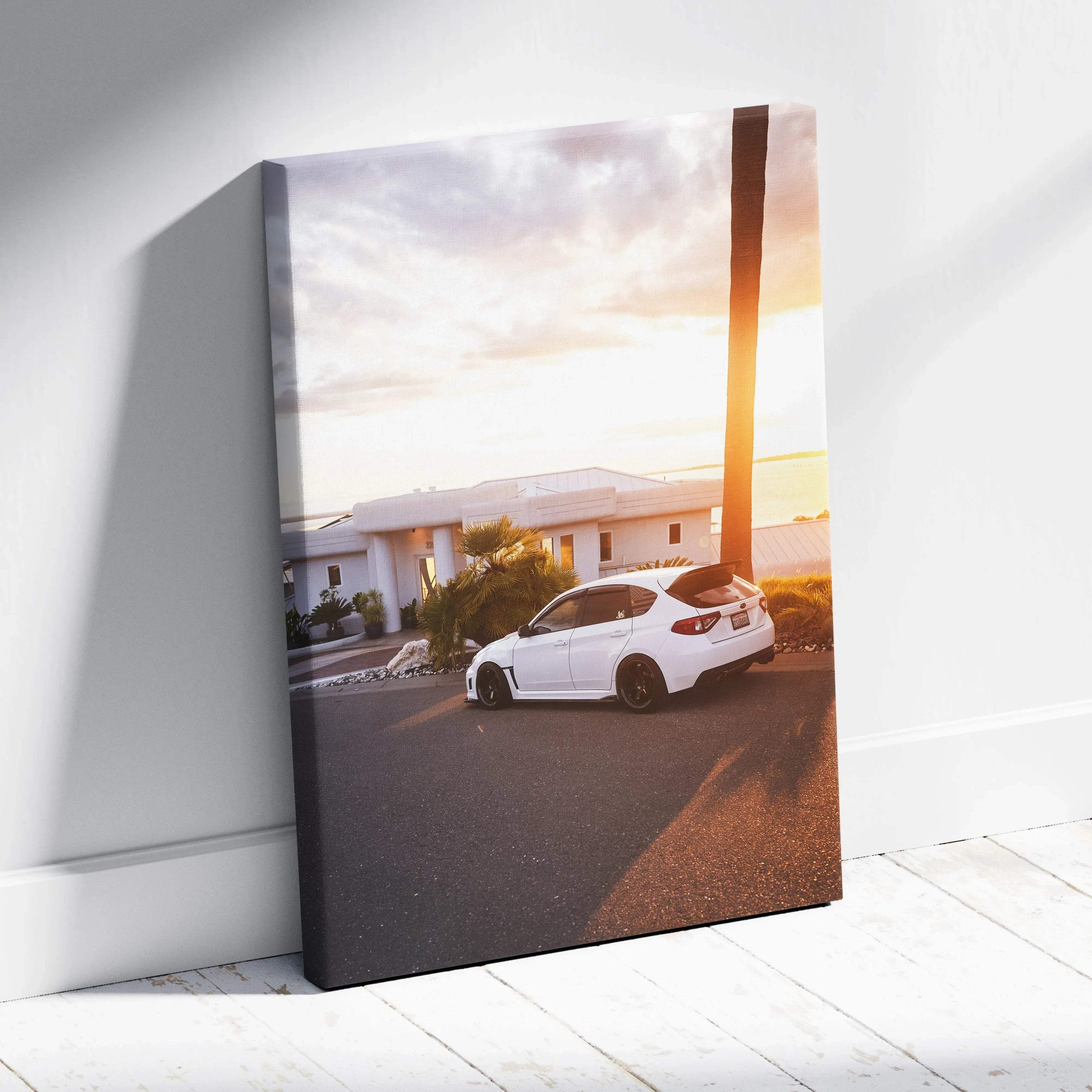 Subaru WRX STI parked at sunset on vertical canvas wall art with warm sky tones.