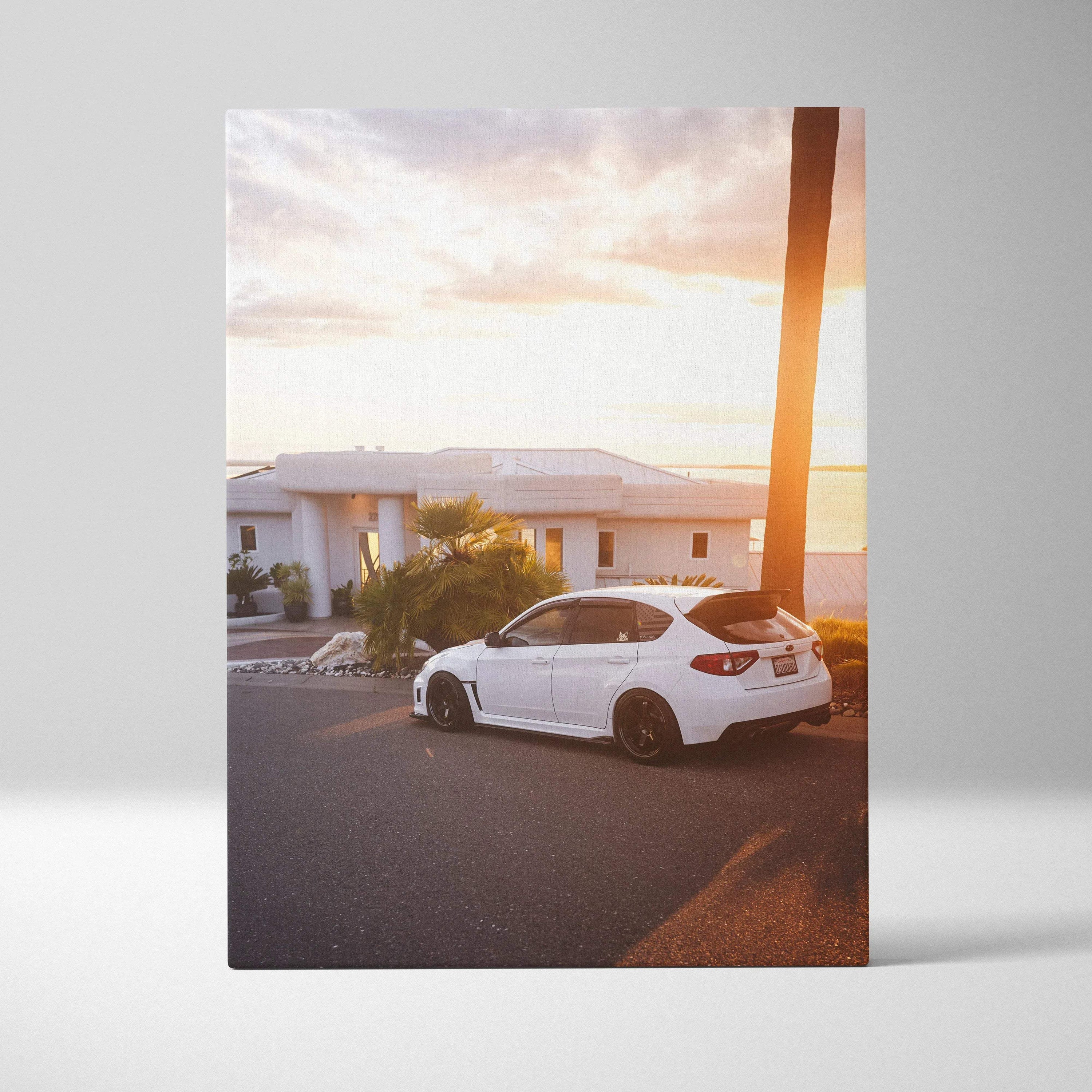 White Subaru WRX STI parked on street at sunset canvas wall art print vertical orientation.