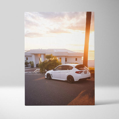 White Subaru WRX STI parked on street at sunset canvas wall art print vertical orientation.