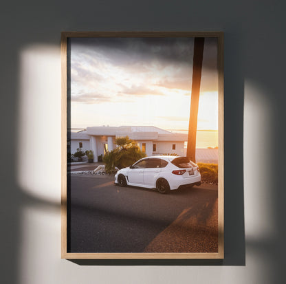 Subaru WRX STI parked on street at sunset poster wall art with warm light and modern frame.