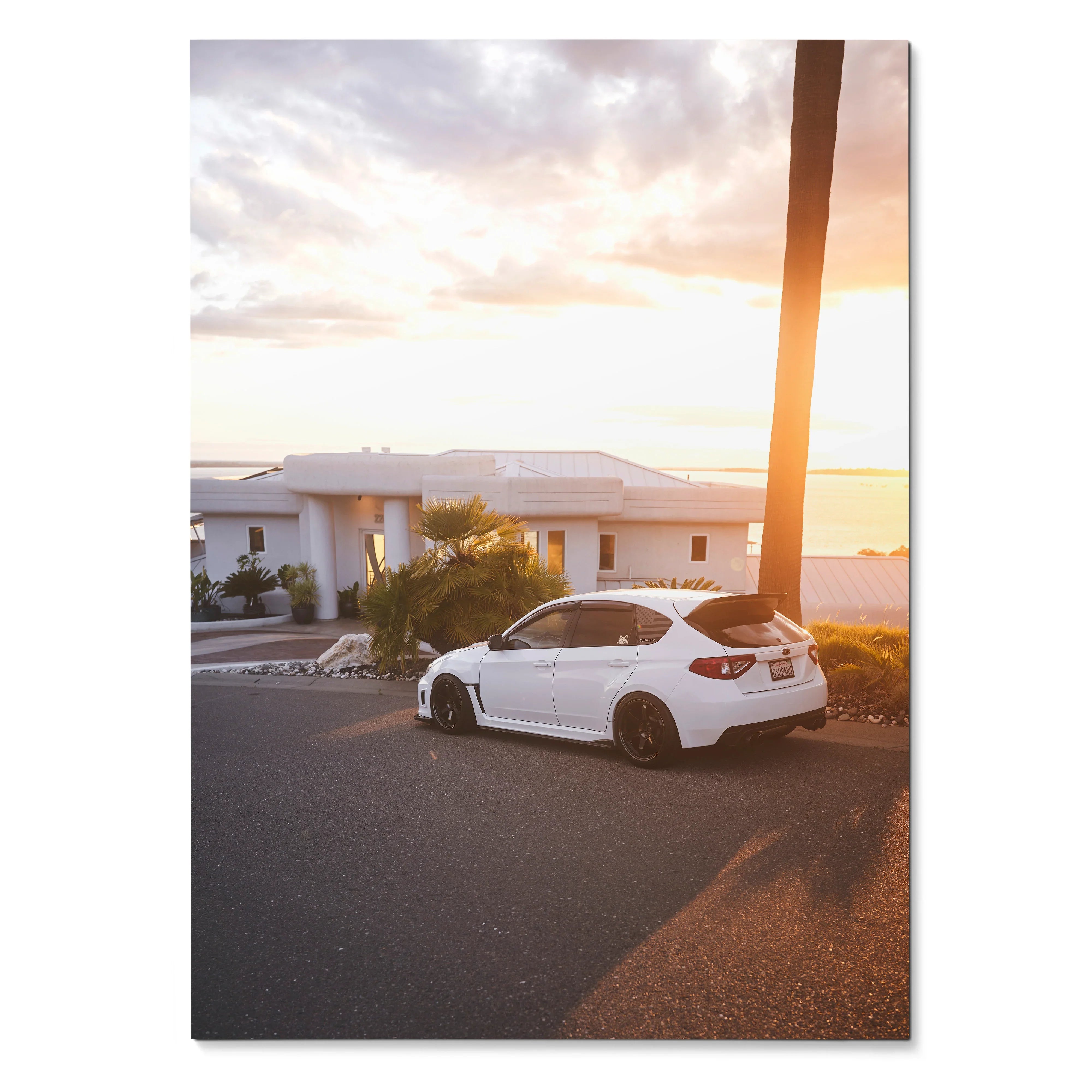 Subaru WRX STI in white parked by modern house at sunset poster wall art.