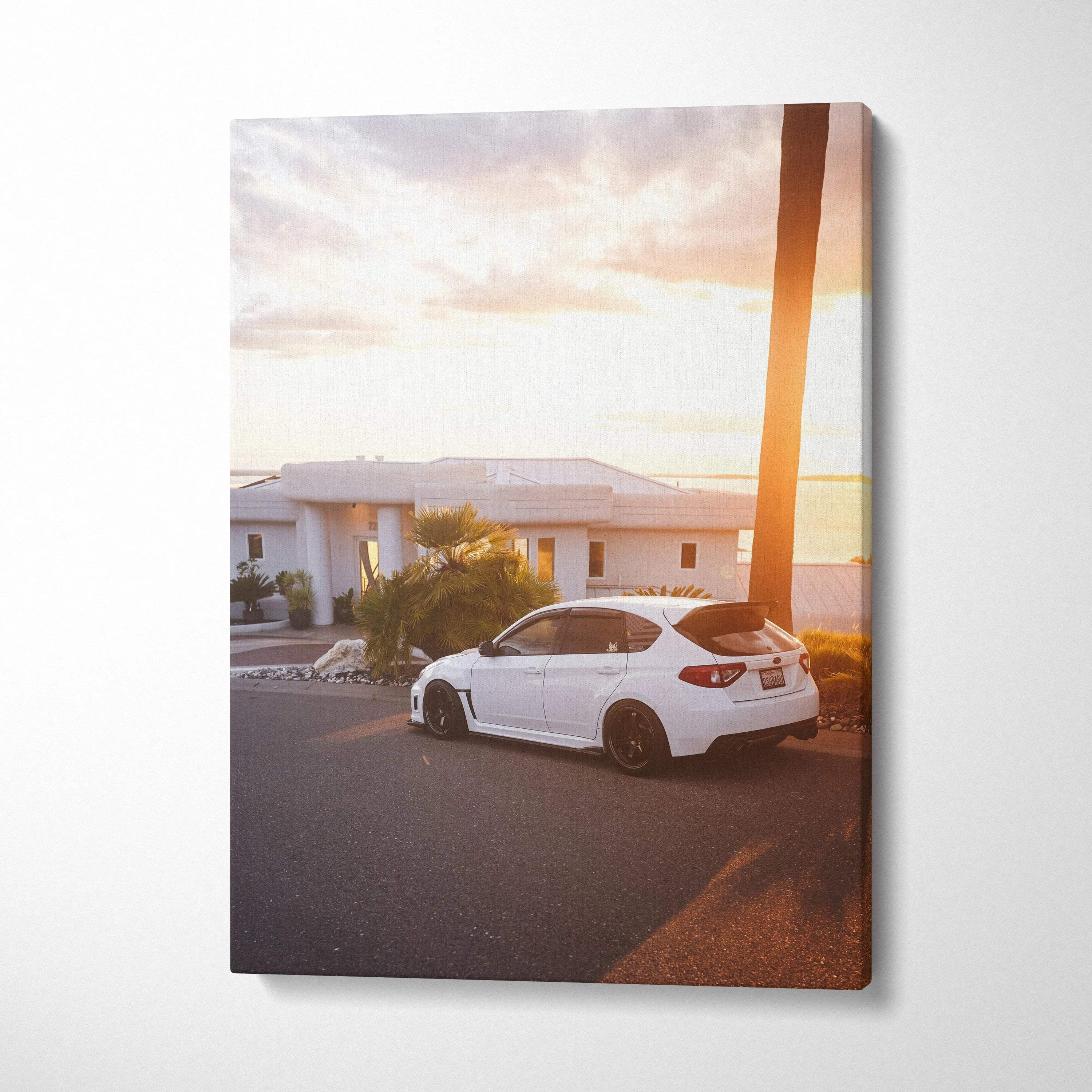 Subaru WRX STI white car parked by palm tree at sunset vertical canvas wall art.