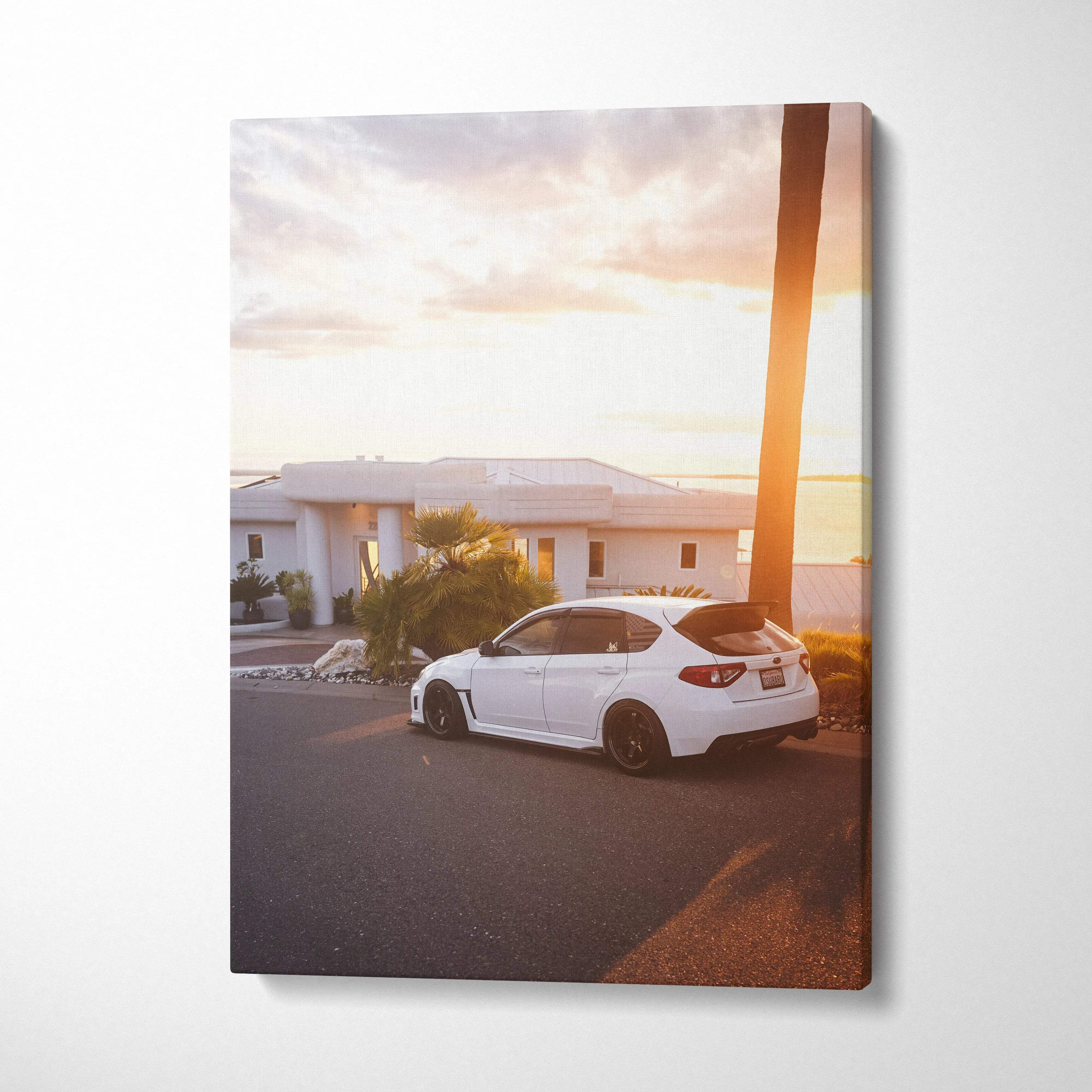Subaru WRX STI white car parked by palm tree at sunset vertical canvas wall art.