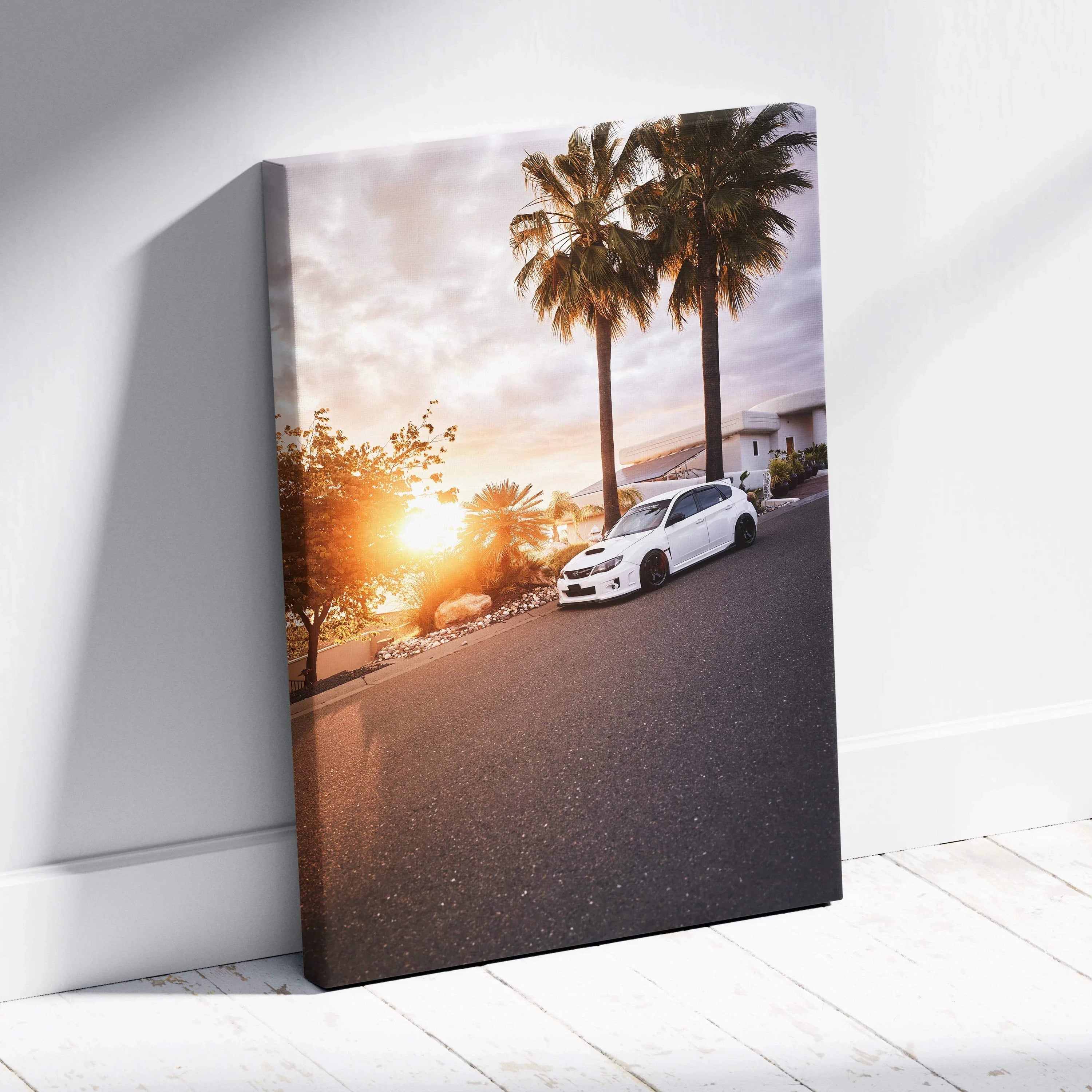 Subaru WRX STI parked on street at sunset with palm trees canvas wall art.