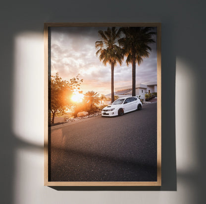 Subaru WRX STI parked by palm trees at sunset automotive poster wall art in wooden frame.