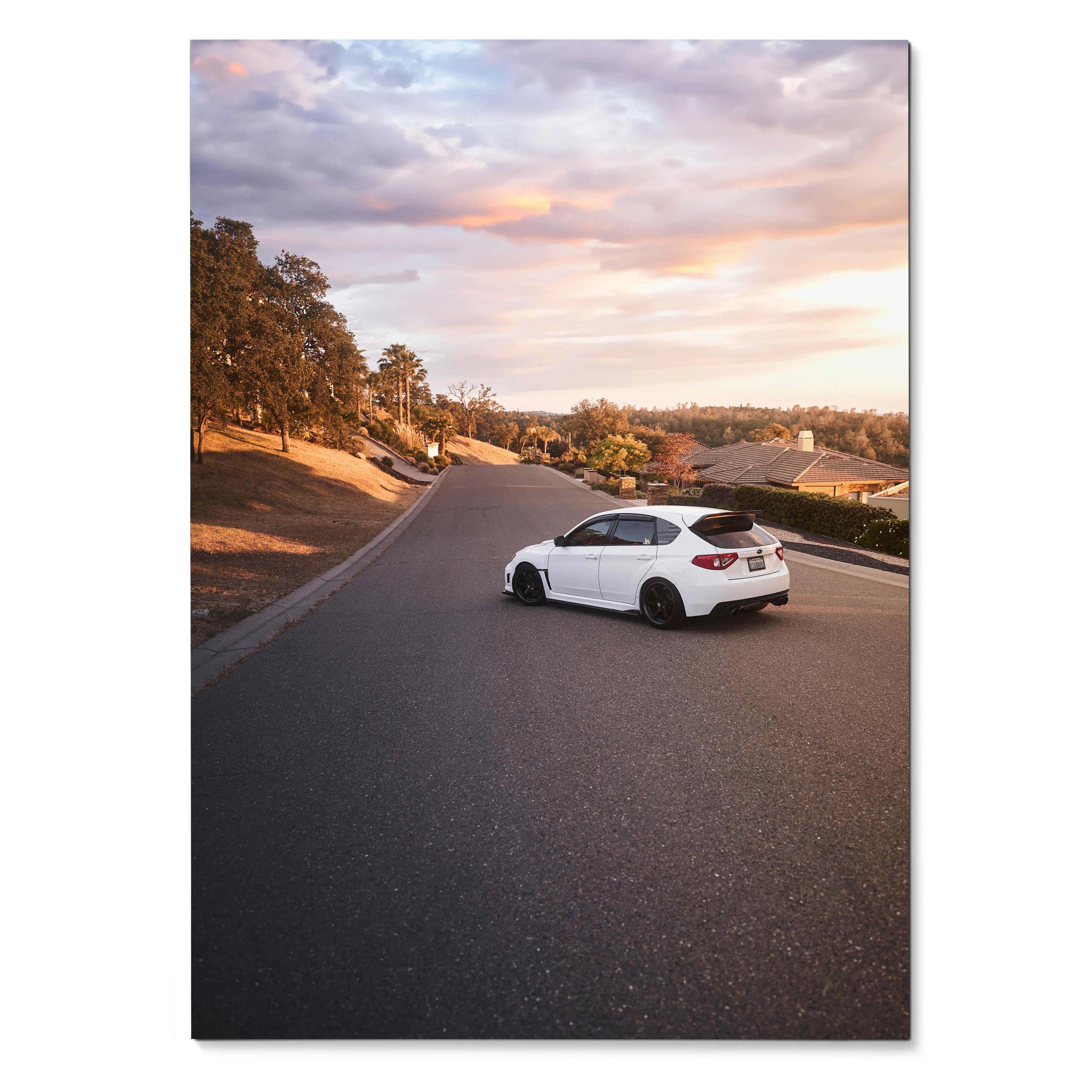 Subaru WRX STI parked on suburban road at sunset poster wall art with warm sky colors.