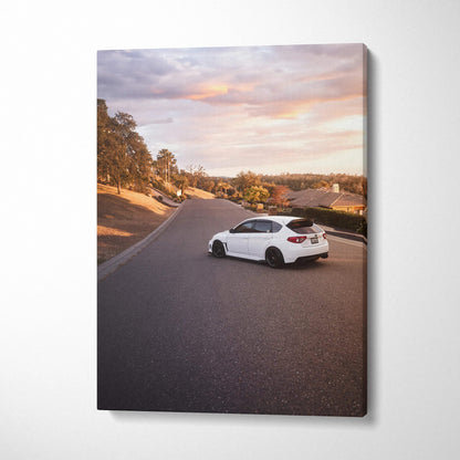Subaru WRX STI on road at sunset vertical canvas wall art with warm sky and landscape background.