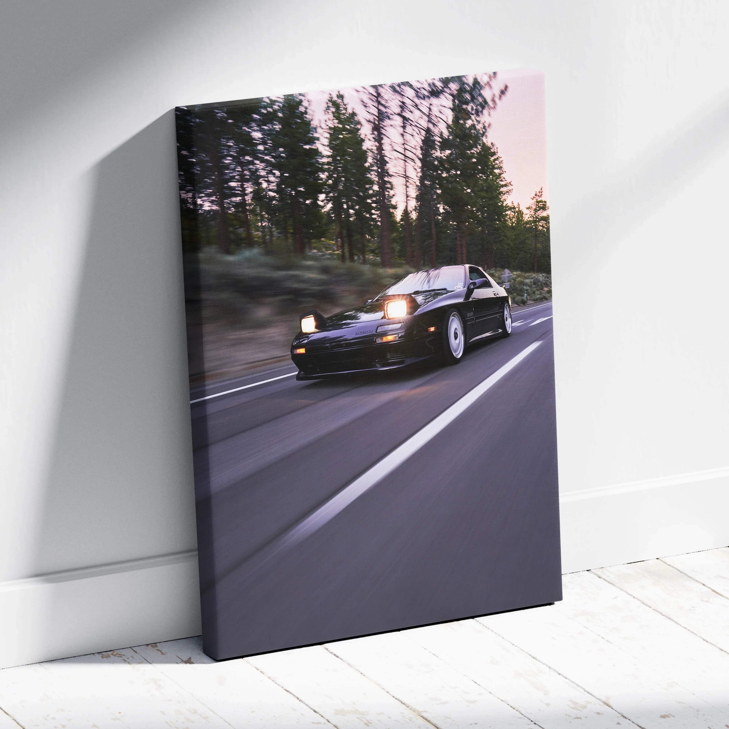 Mazda FC RX7 driving on road at dusk canvas wall art with pine trees background.