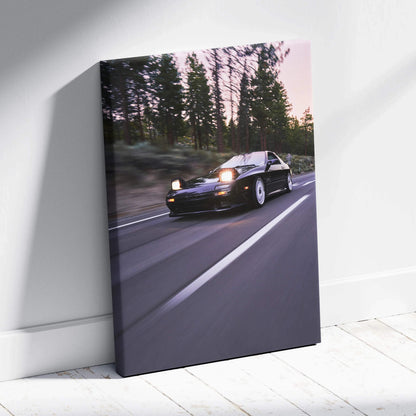 Mazda FC RX7 driving on road at dusk canvas wall art with pine trees background.