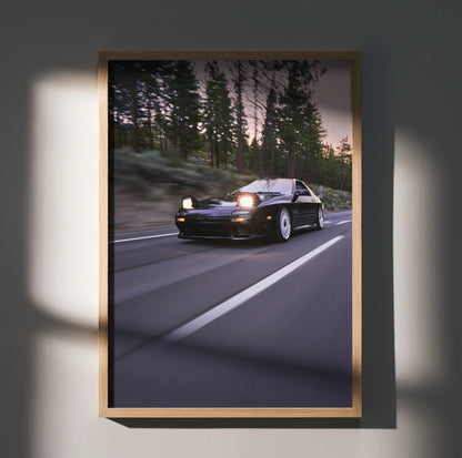 Mazda FC RX7 driving on forest road at dusk poster wall art in wooden frame.