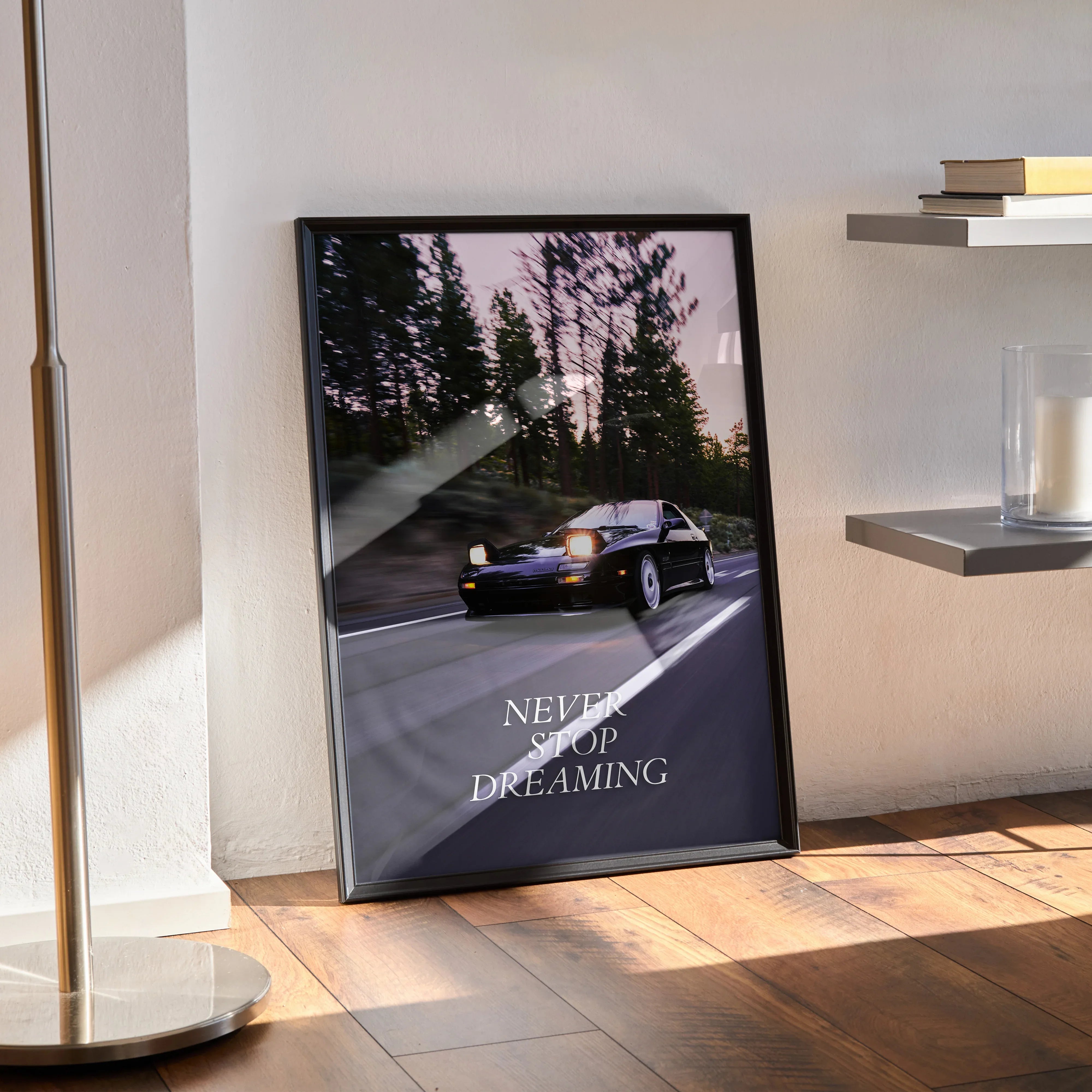 Motivational poster featuring a black FC Mazda RX7 driving on a road with forest background and inspiring text "Never Stop.
