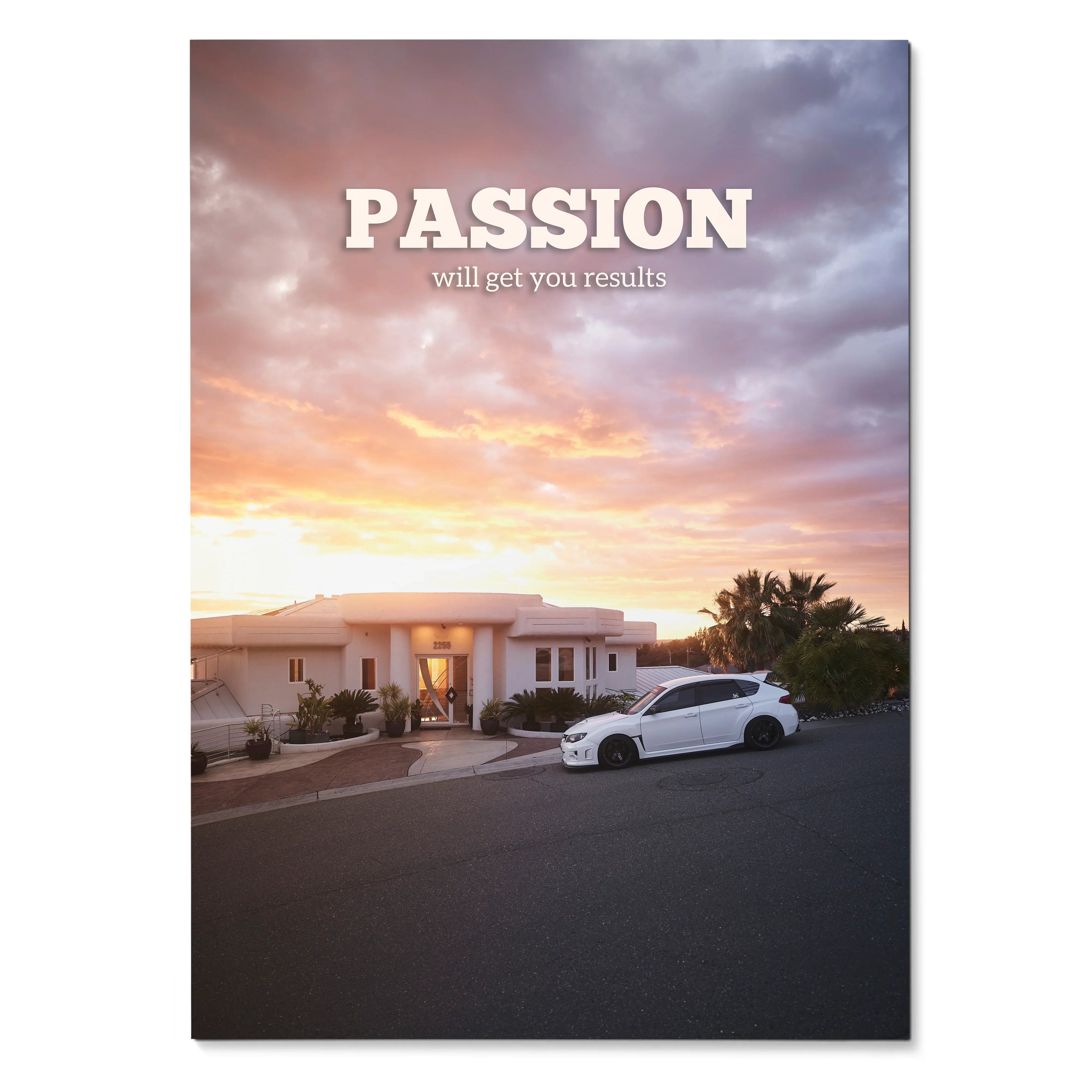 Motivational poster wall art with white Subaru WRX STI parked in front of modern house at sunset.