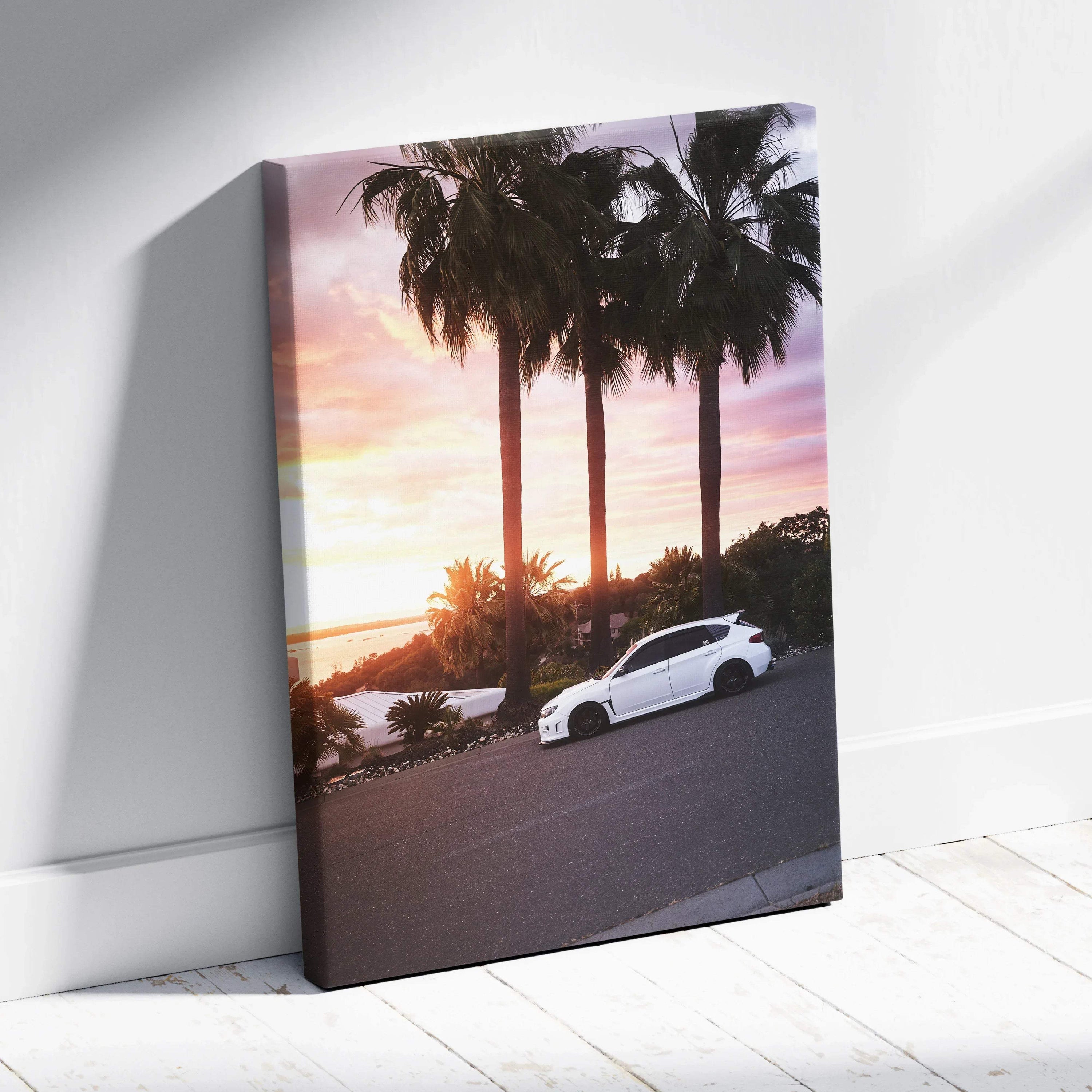 White Subaru WRX STI parked by palm trees at sunset on vertical canvas wall art.