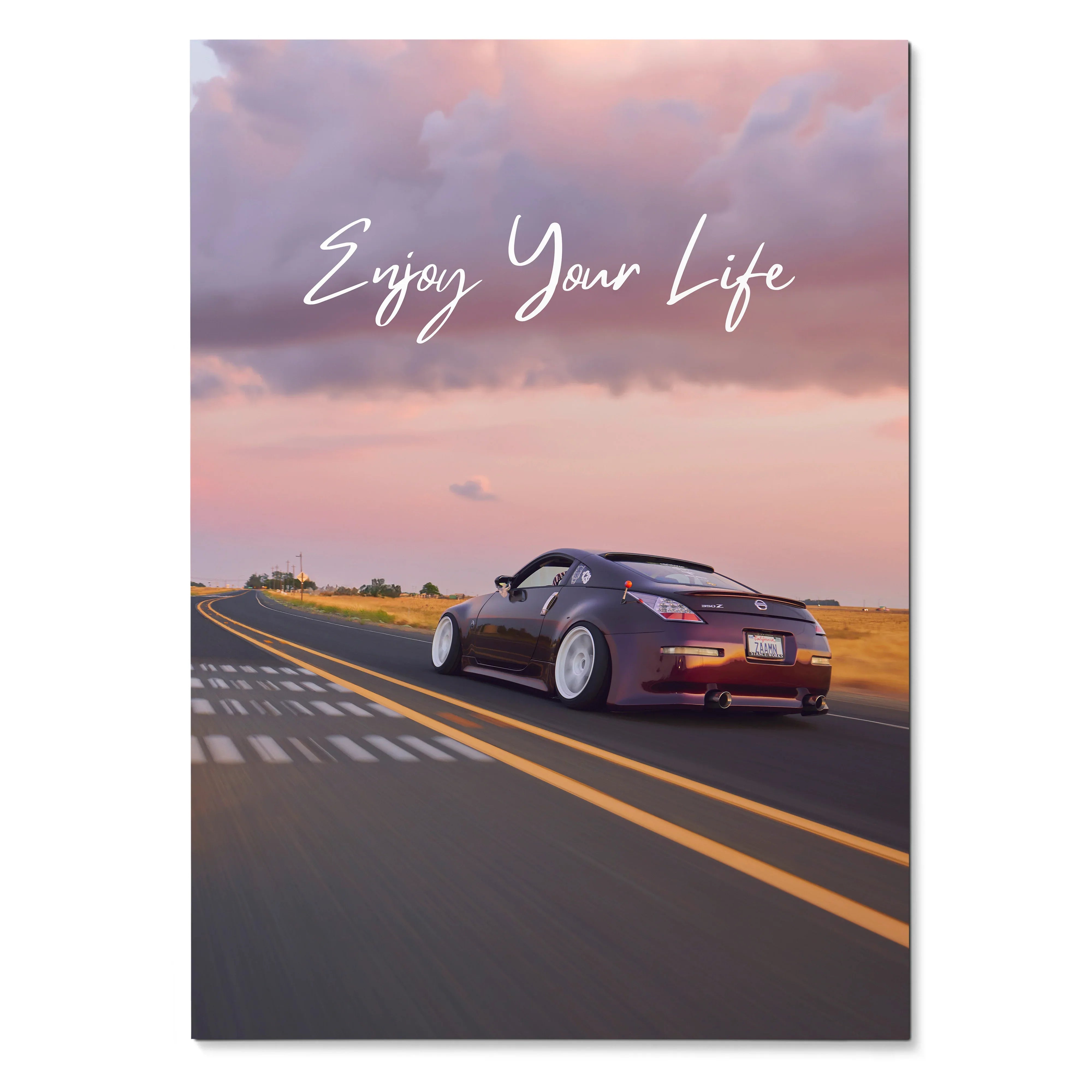 Poster wall art featuring a black Nissan 350z on an open road at sunset with "Enjoy Your Life" text.