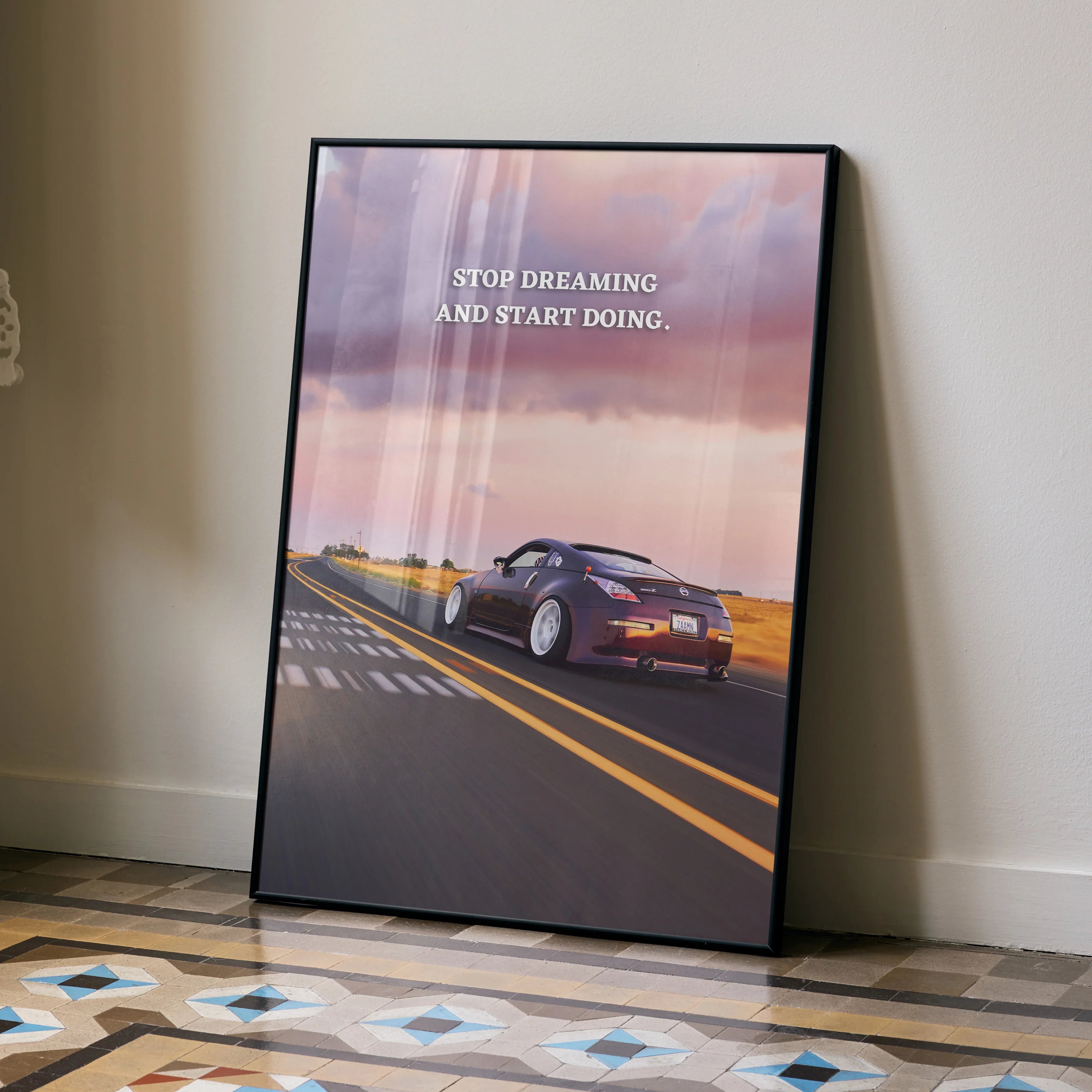 Motivational poster wall art featuring Nissan 350z driving on open road at sunset with quote "Stop dreaming and start doing".