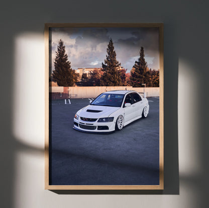 White Mitsubishi Evo 8 parked in empty lot with trees and building background poster wall art.