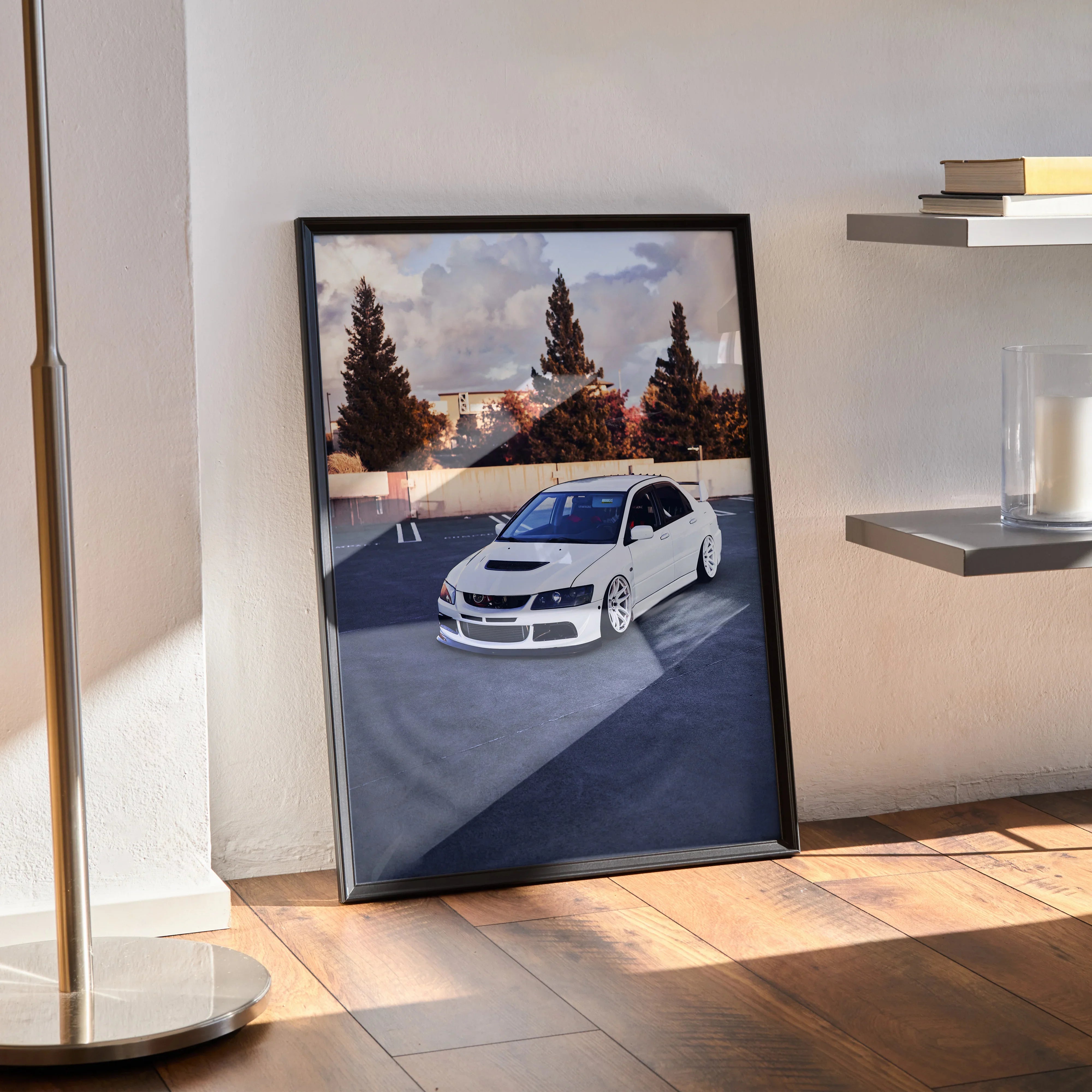 Mitsubishi Evo 8 white car poster wall art in black frame leaning on wooden floor.