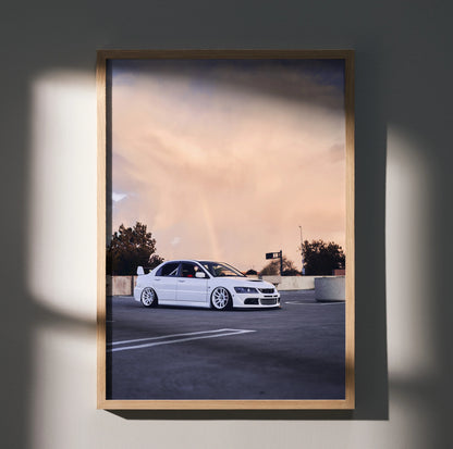 Mitsubishi Evo 8 poster wall art featuring white car on asphalt under a soft sunset sky with trees and light poles.