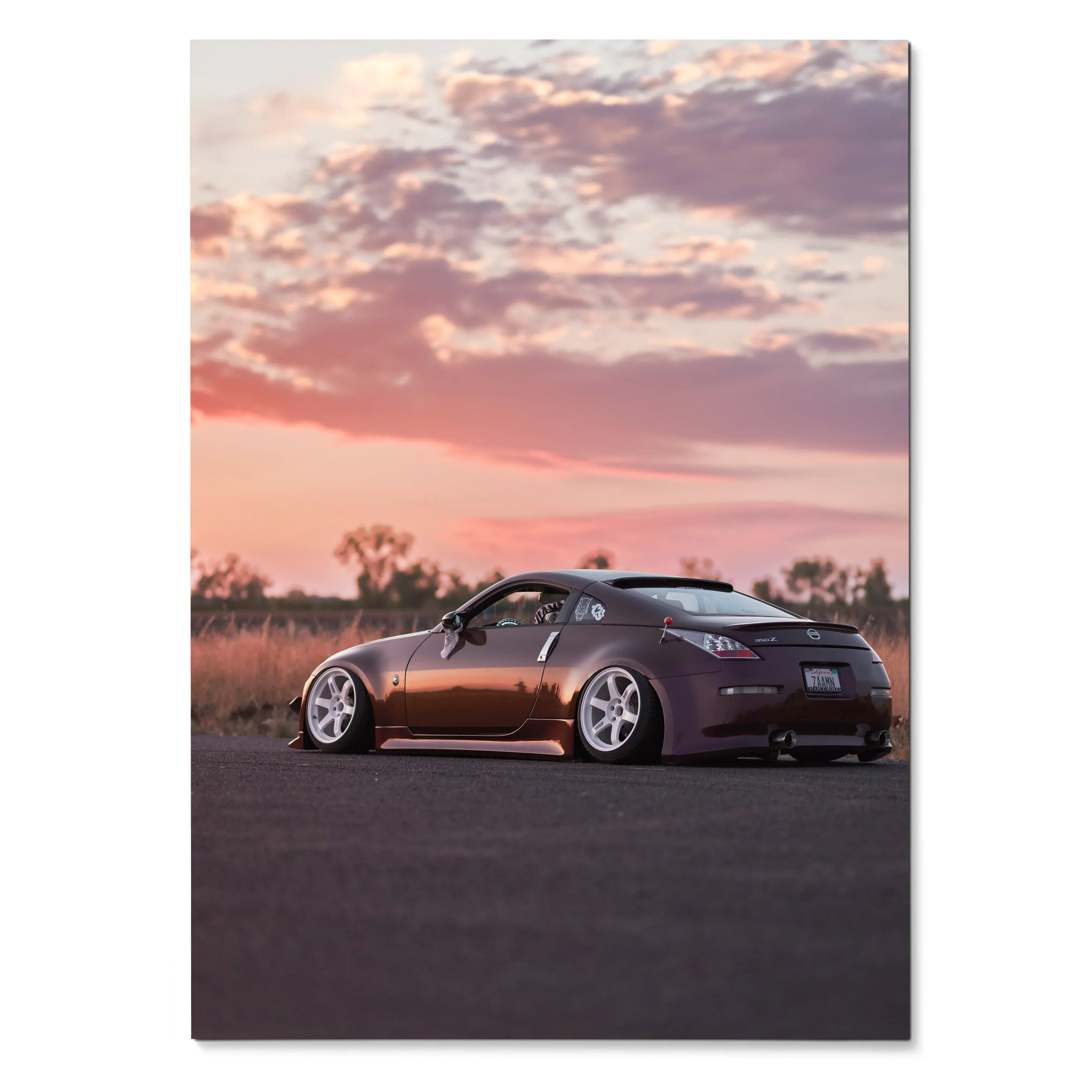 Nissan 350z poster showing side view of dark car on road at sunset sky wall art.