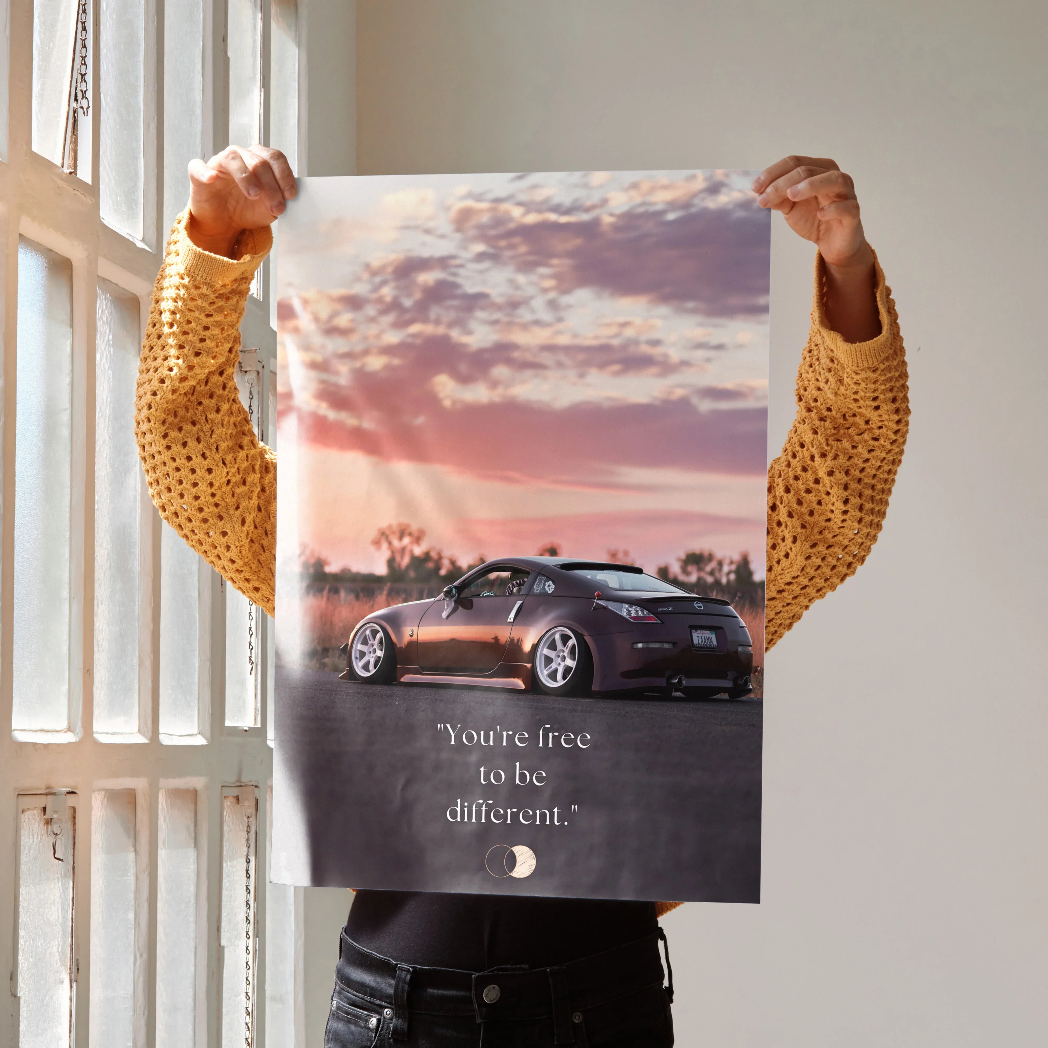 Motivational Nissan 350z poster with sleek black car and inspiring "You're free to be different" text, wall art.