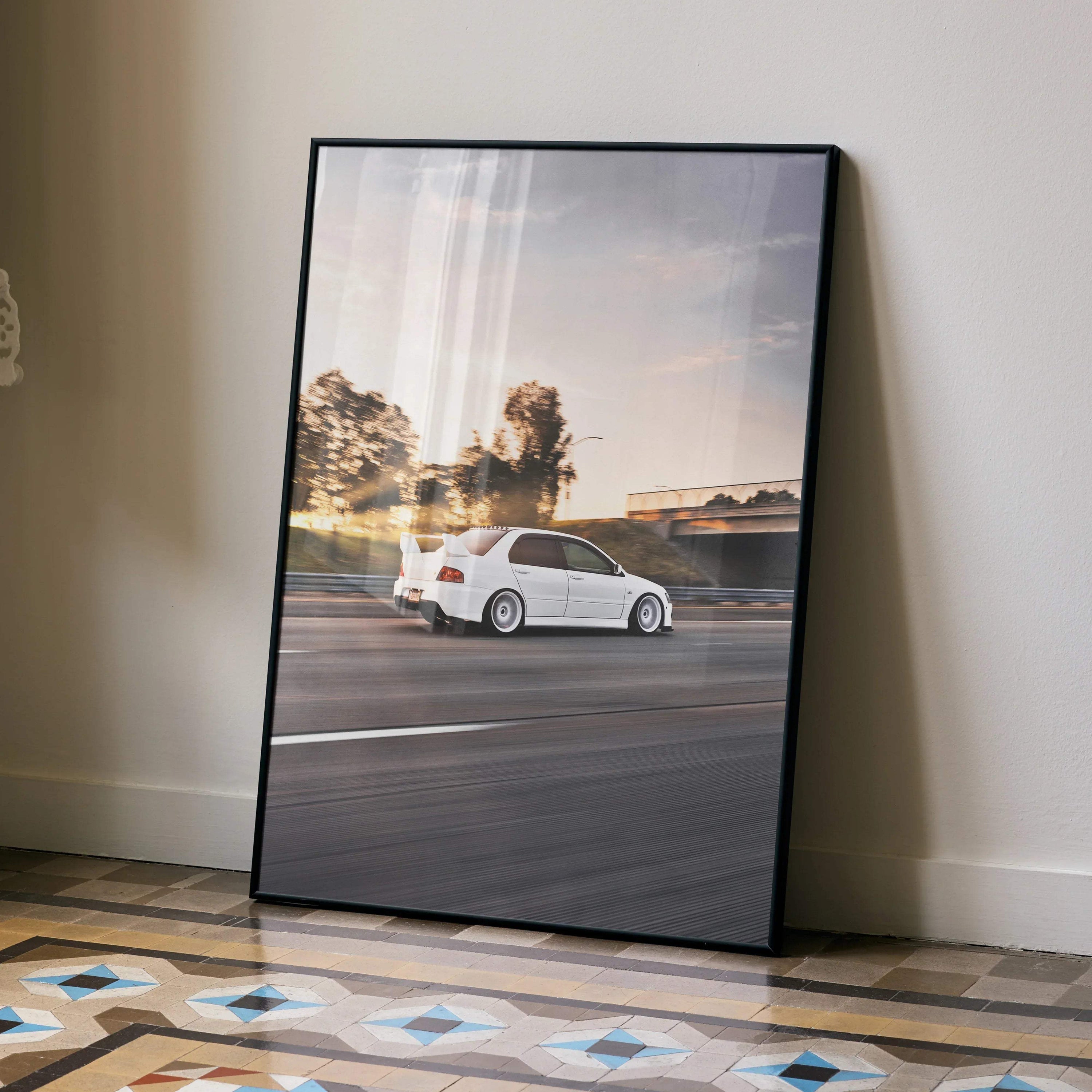 Mitsubishi Evo 8 speeding on road at sunset poster wall art in black frame.