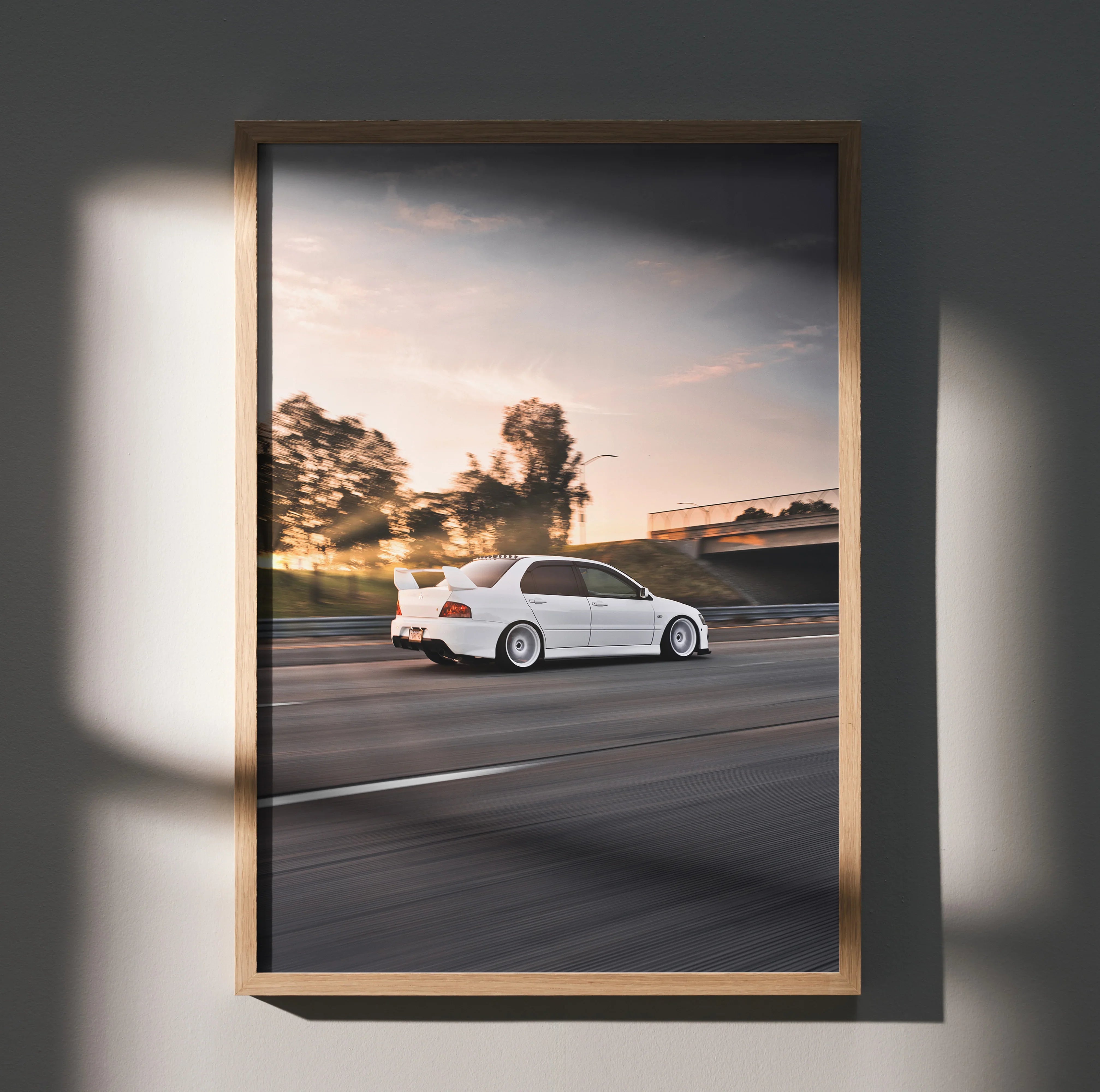 Mitsubishi Evo 8 white car driving at sunset wall art poster with blurred motion background.