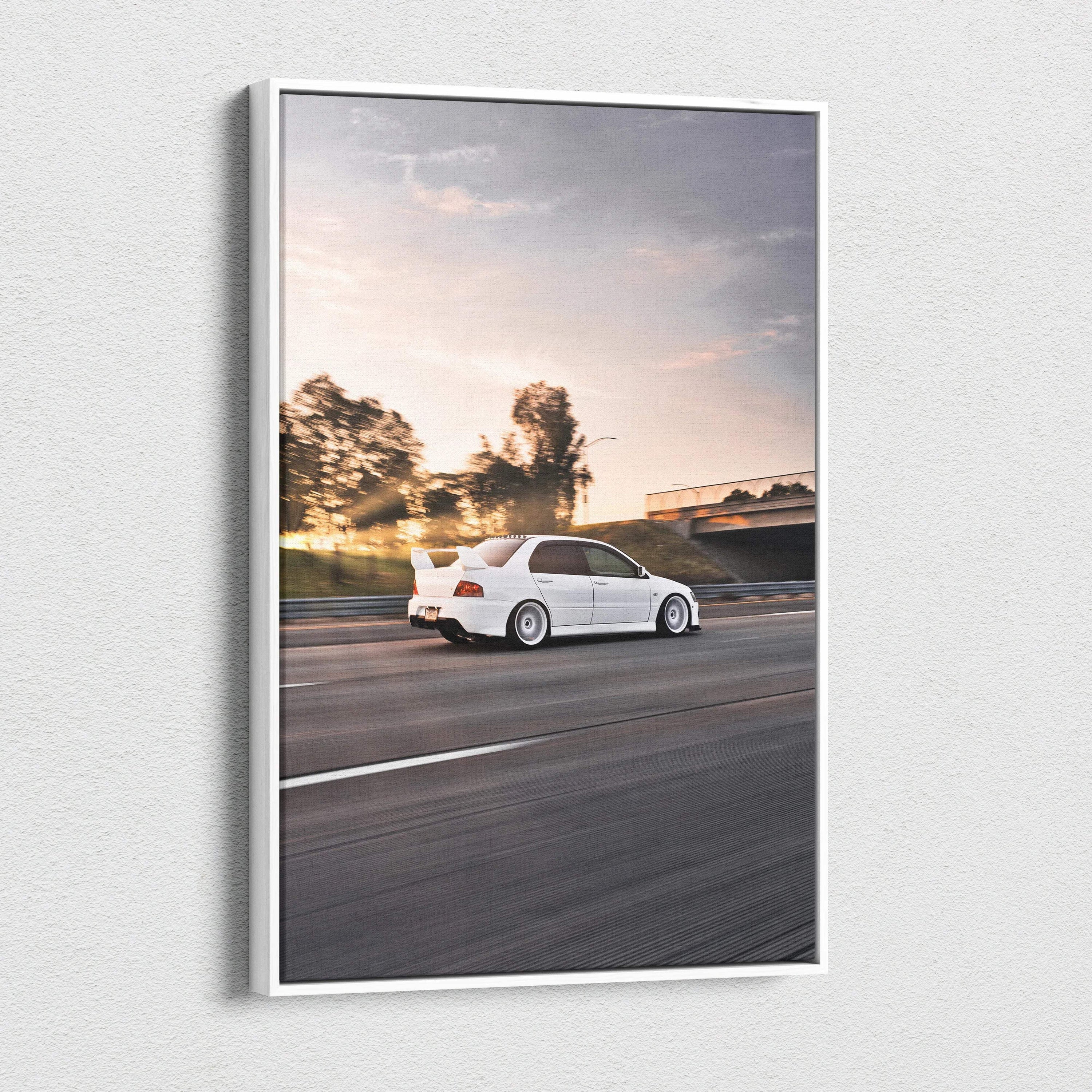 Mitsubishi Evo 8 canvas art wall art featuring a white car driving on a road at sunset.