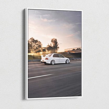 Mitsubishi Evo 8 canvas art wall art featuring a white car driving on a road at sunset.