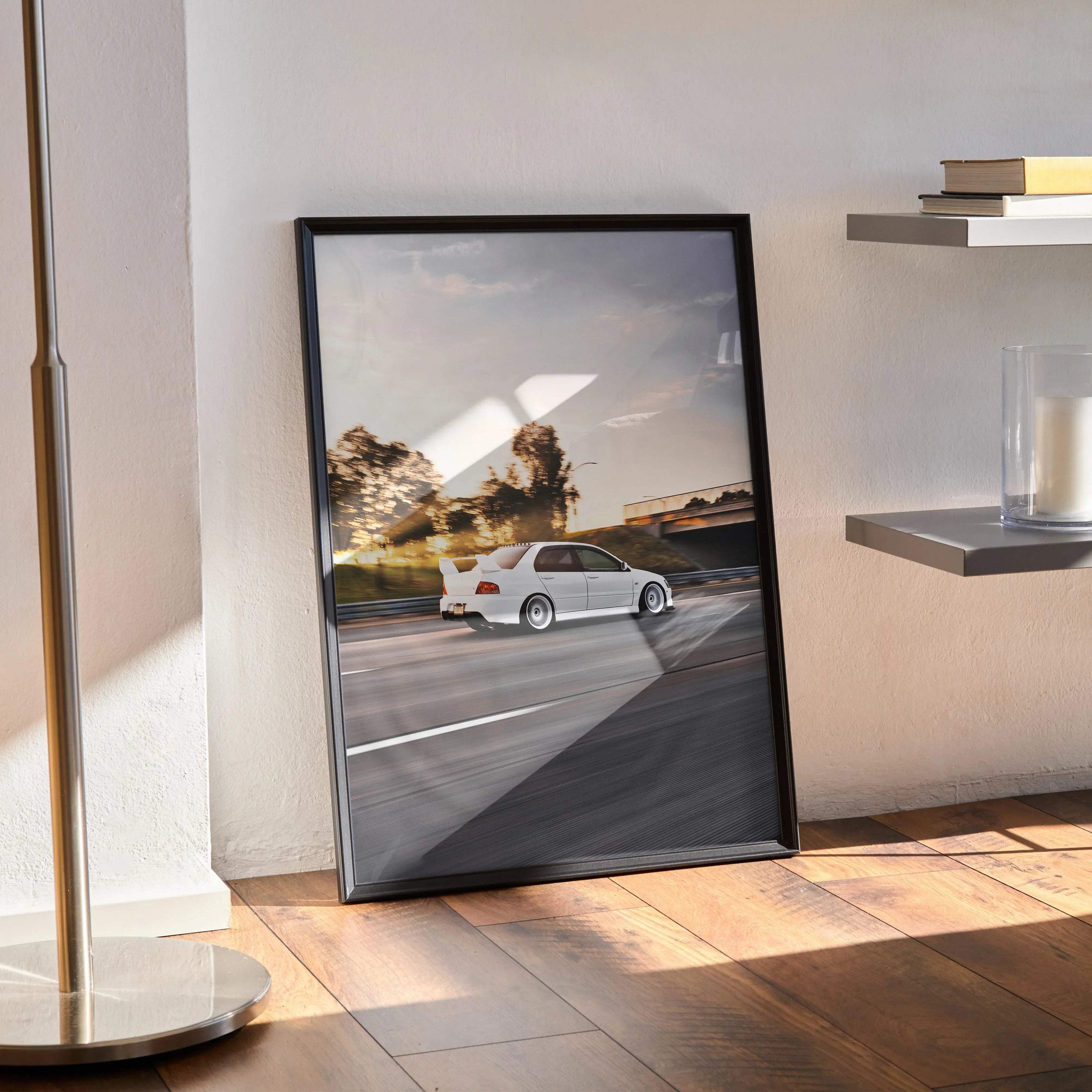 Mitsubishi Evo 8 poster wall art showing white car on road at sunset in black frame.