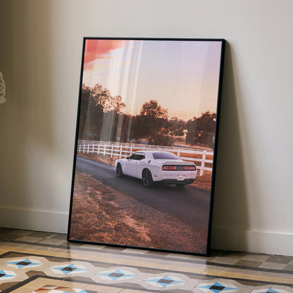 Dodge Challenger poster wall art featuring a white muscle car on a country road at sunset.