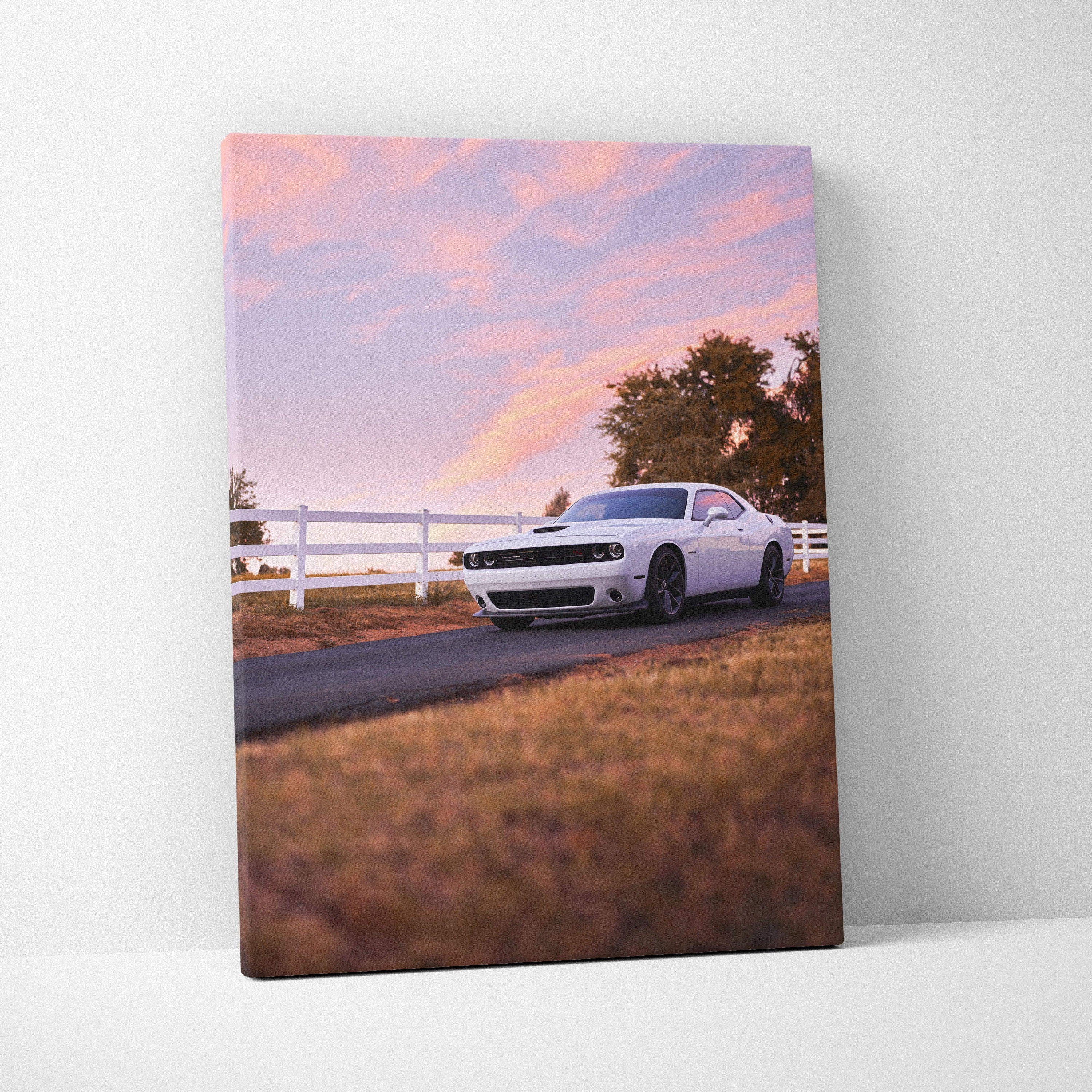 White Dodge Challenger parked on country road with sunset sky canvas wall art.