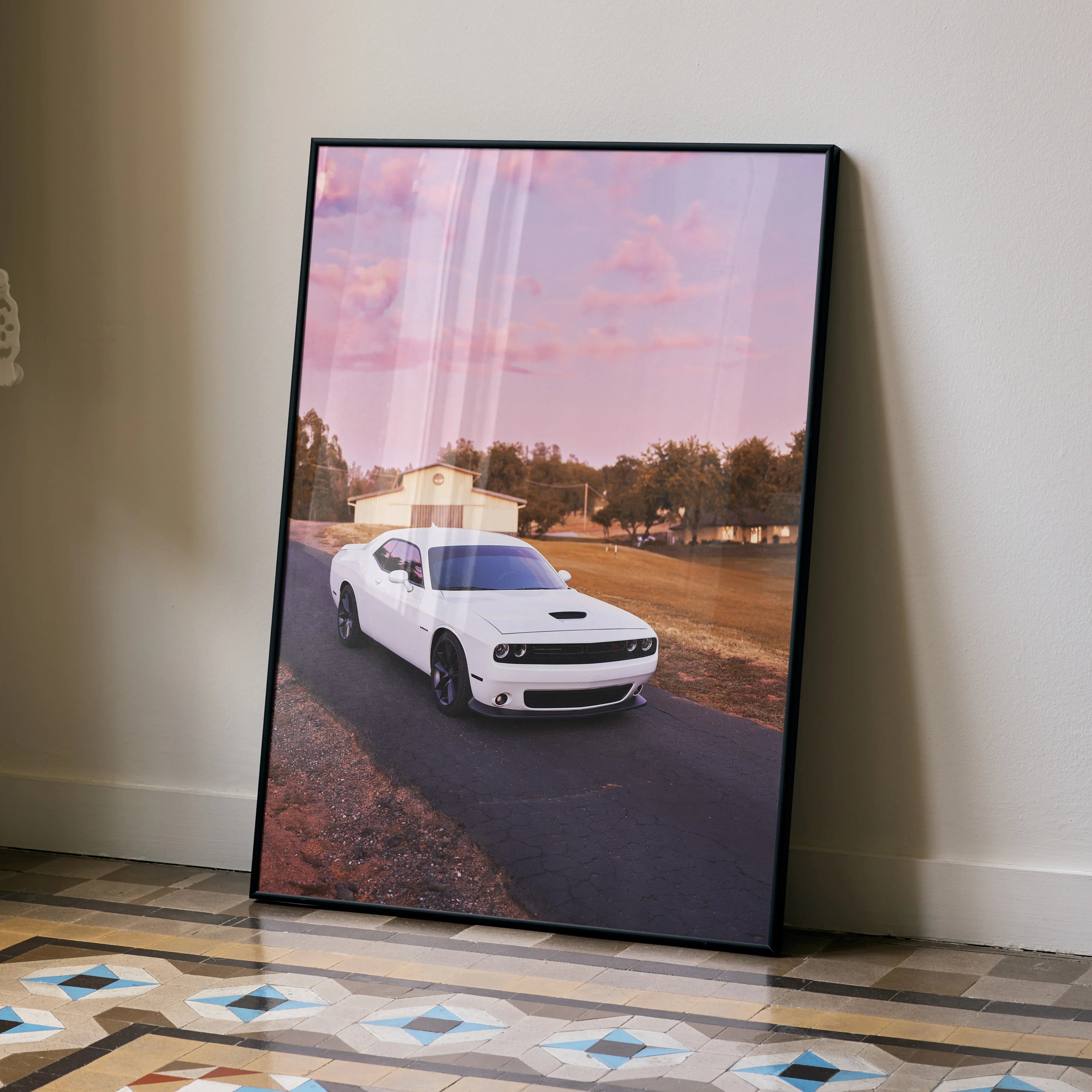 White Dodge Challenger driving on road at sunset framed poster wall art.