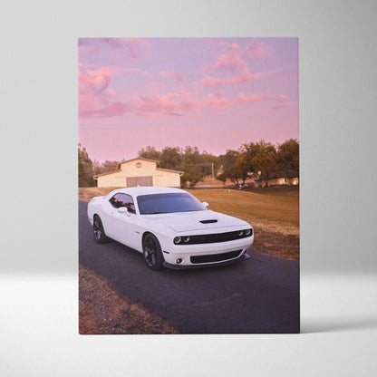 White Dodge Challenger on road at sunset with pink sky canvas wall art print.