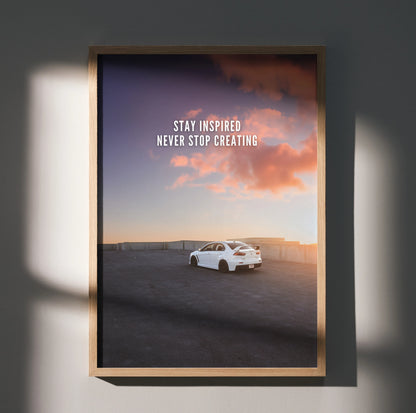 Motivational poster wall art with white Mitsubishi Evo 10 under vibrant sunset sky and inspiring text.