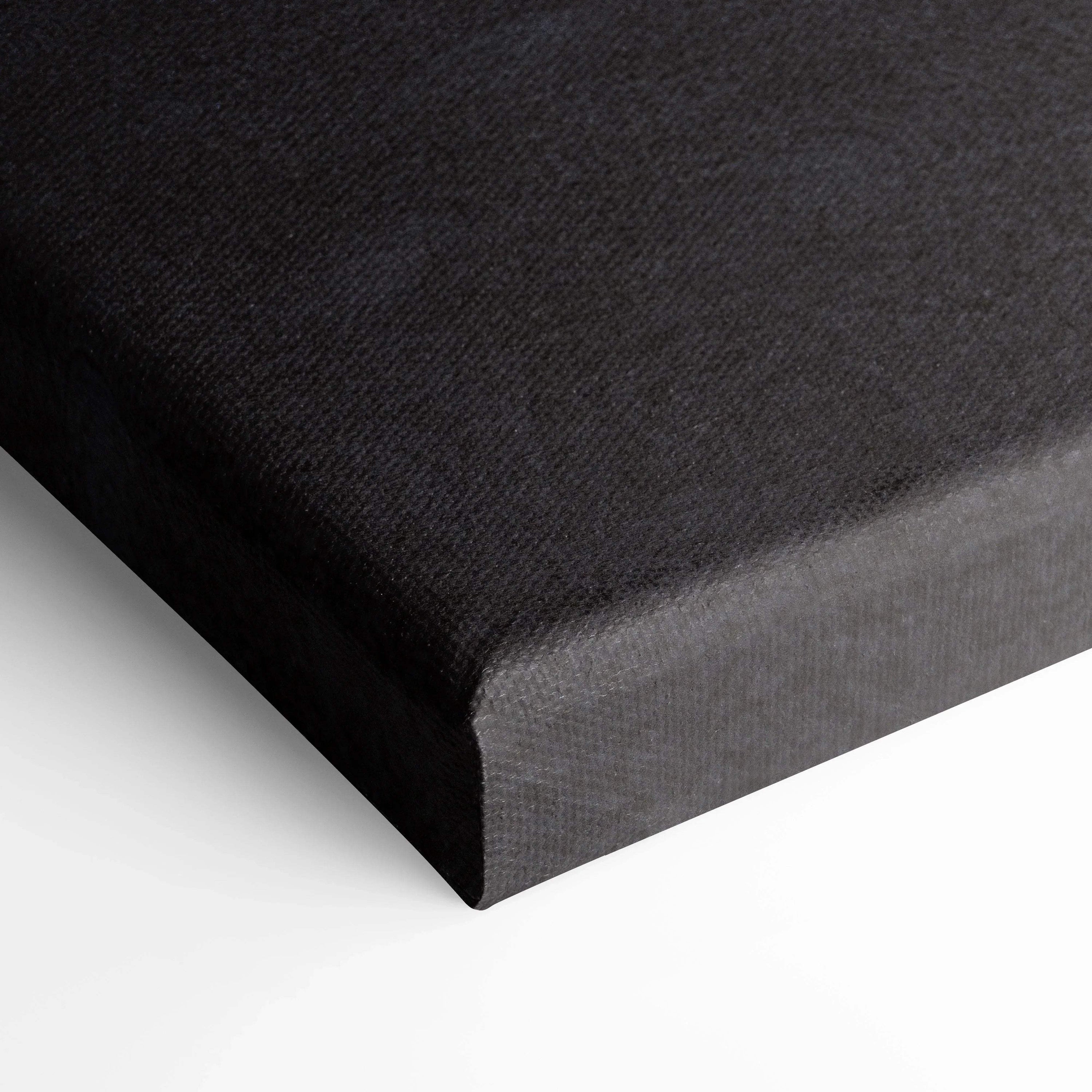 Black textured canvas corner showing wrapped edges for vertical wall art canvas print.