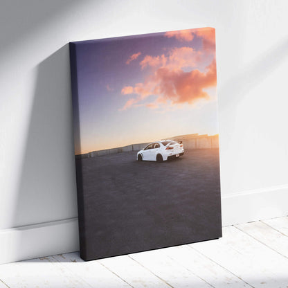 Vertical canvas wall art featuring a white Mitsubishi Evo 10 under a colorful sunset sky.