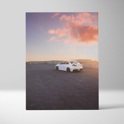White Mitsubishi Evo 10 parked on rooftop at sunset canvas wall art in vertical format.