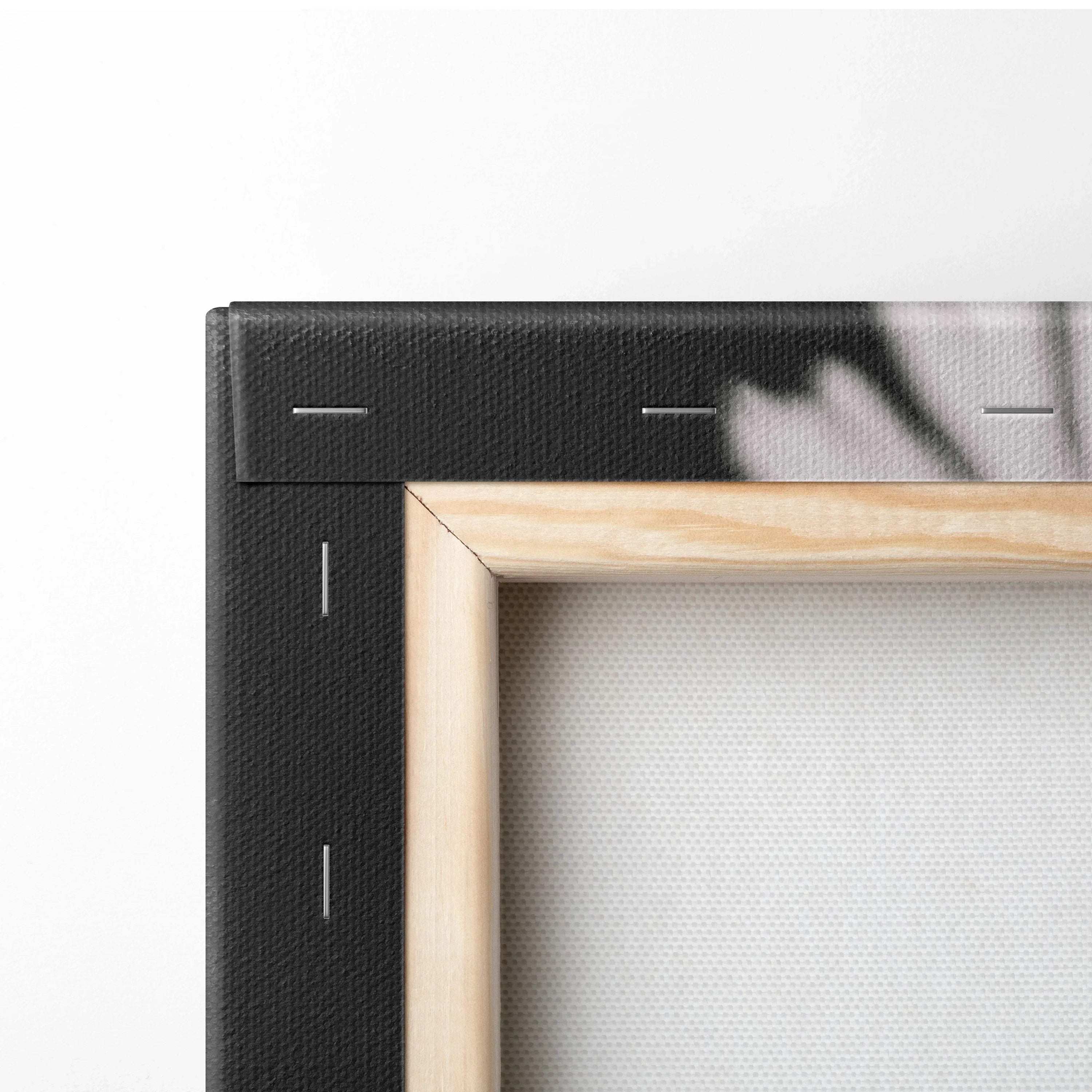 Close-up of stretched canvas corner with wooden frame and black backing for wall art decor.